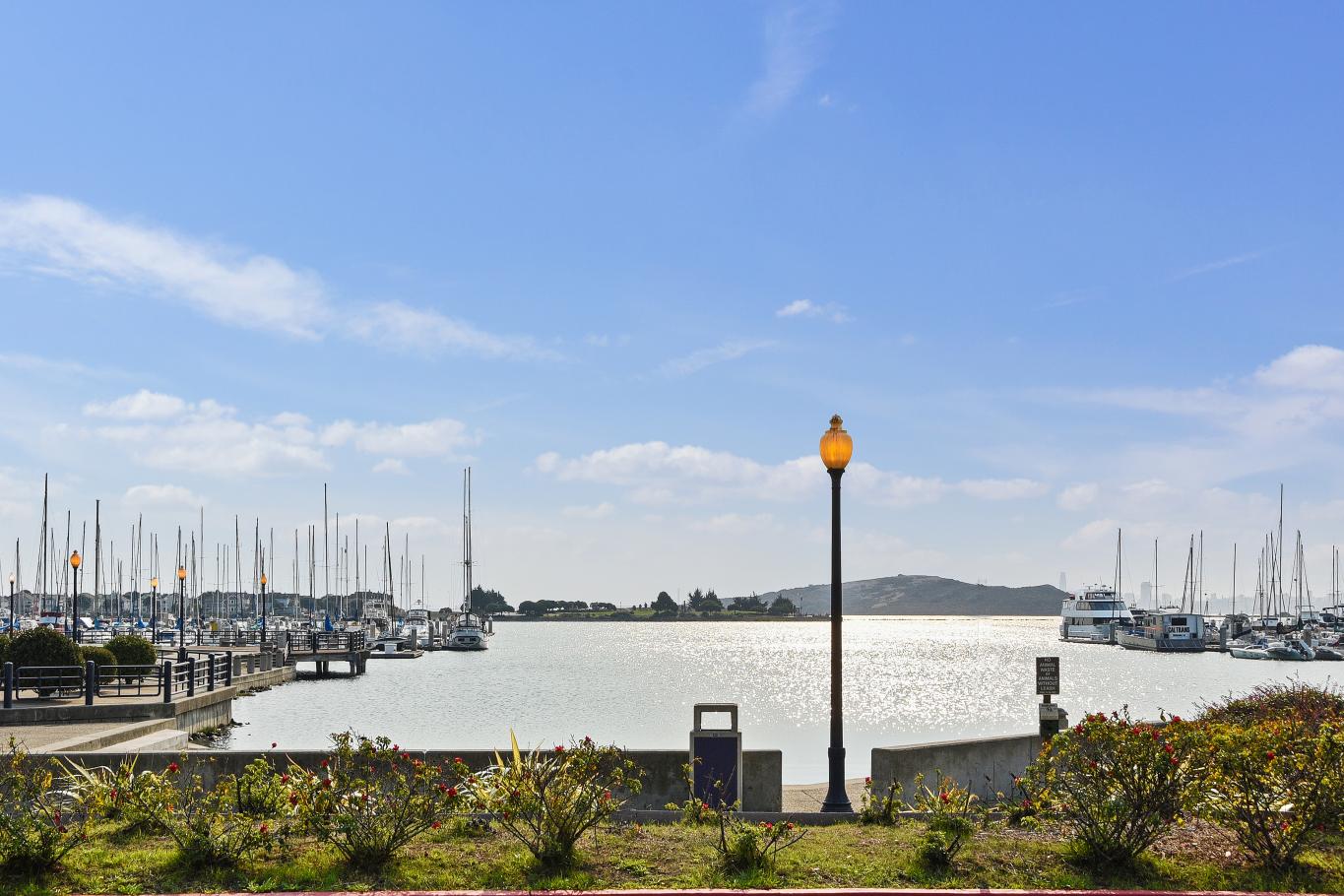 Marina Bay waterfront and sailboat marina in Richmond, California, with boats, landscaped shoreline, and bay views near 189 Schooner Ct.