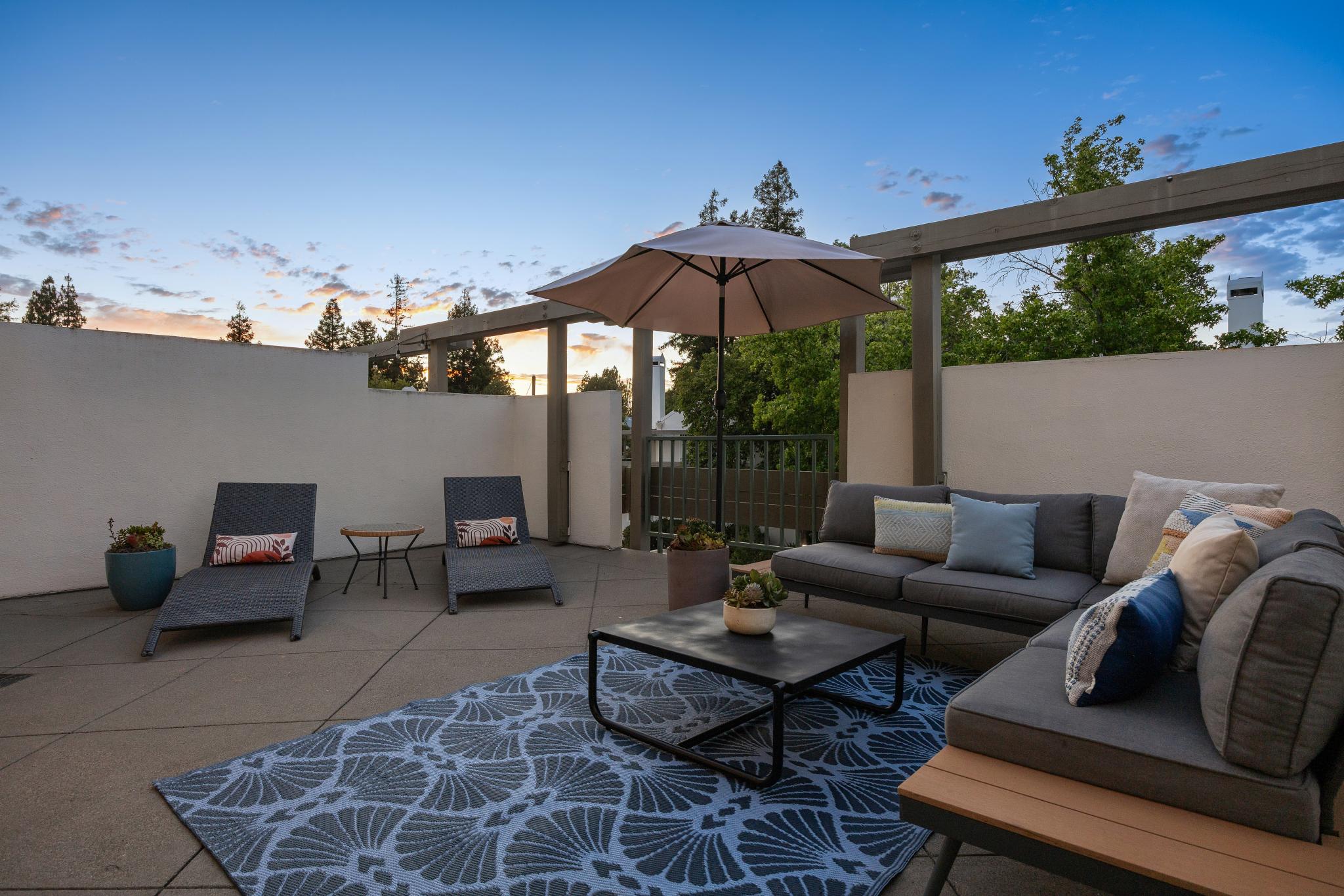 Private lower patio and outdoor seating area at 36 Mozden Ln