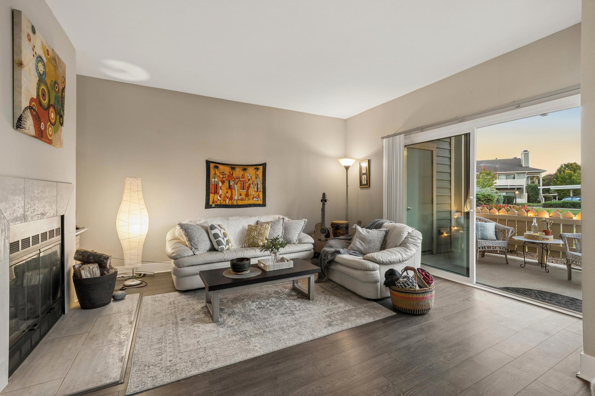 Living room with fireplace and patio doors at Lakeshore Court in Marina Bay, Richmond