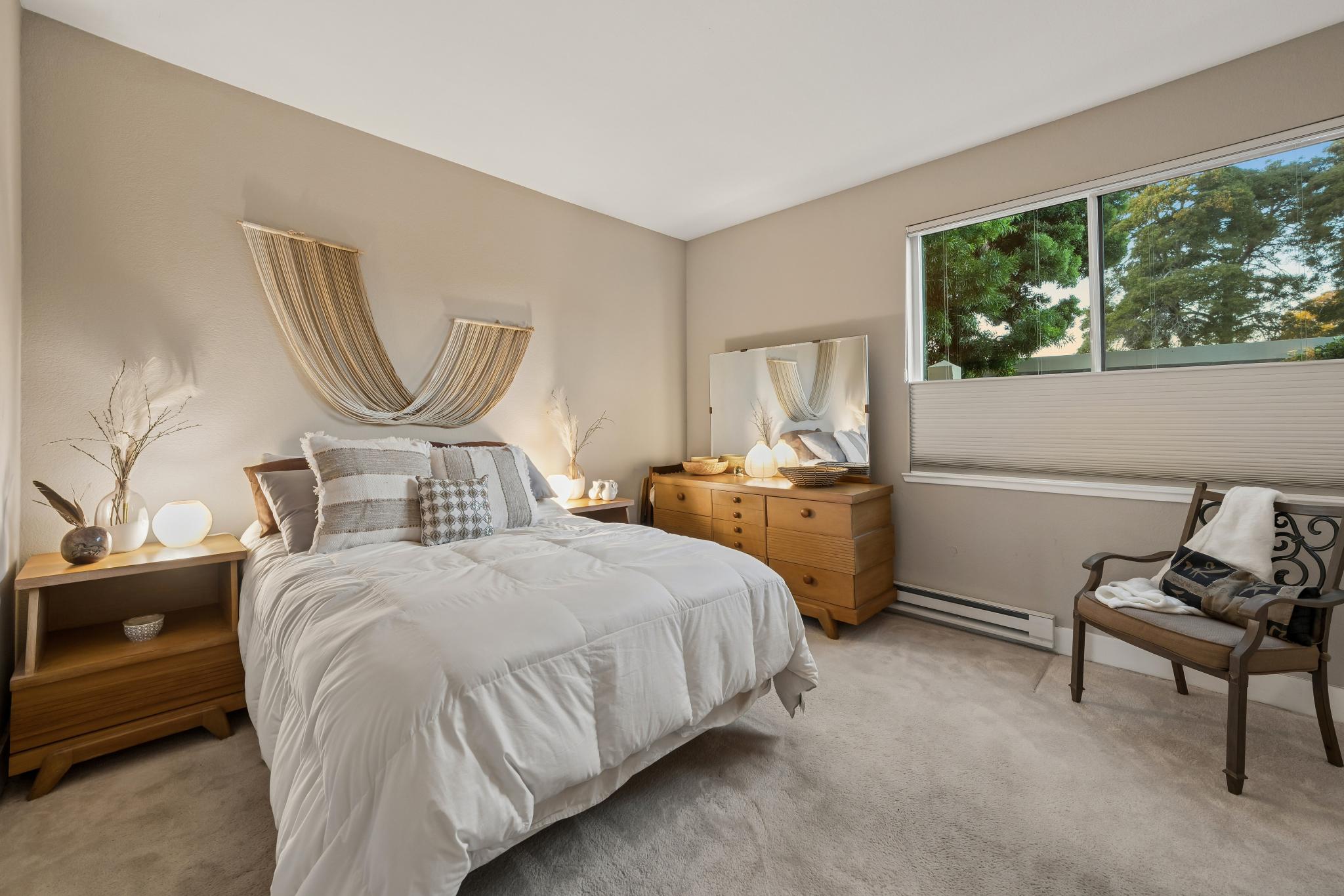 Bedroom with wide window at Lakeshore Court in Marina Bay, Richmond
