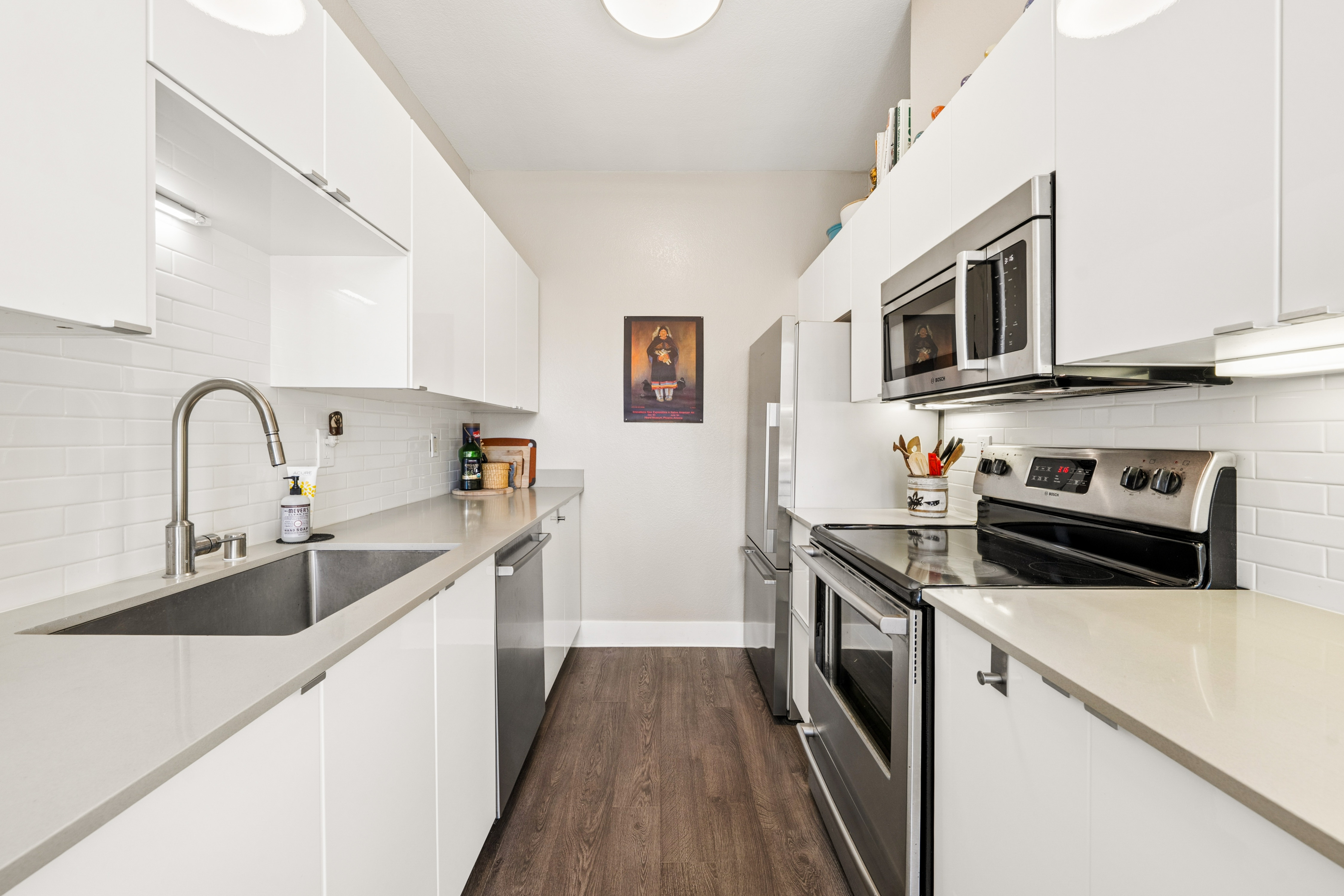 White kitchen with stainless steel appliances at Lakeshore Court in Marina Bay, Richmond