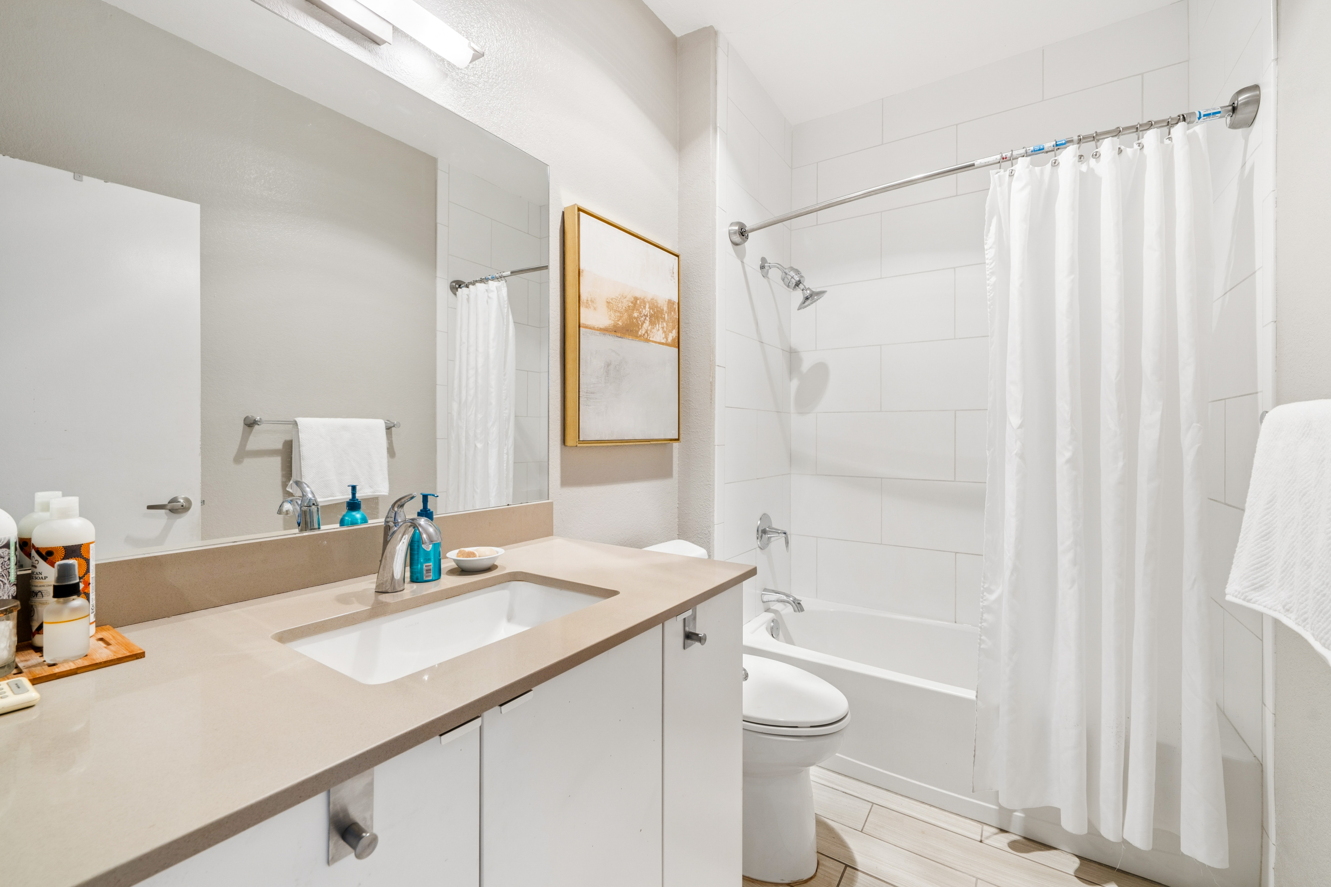 Bathroom with vanity and shower over tub at Lakeshore Court in Marina Bay, Richmond