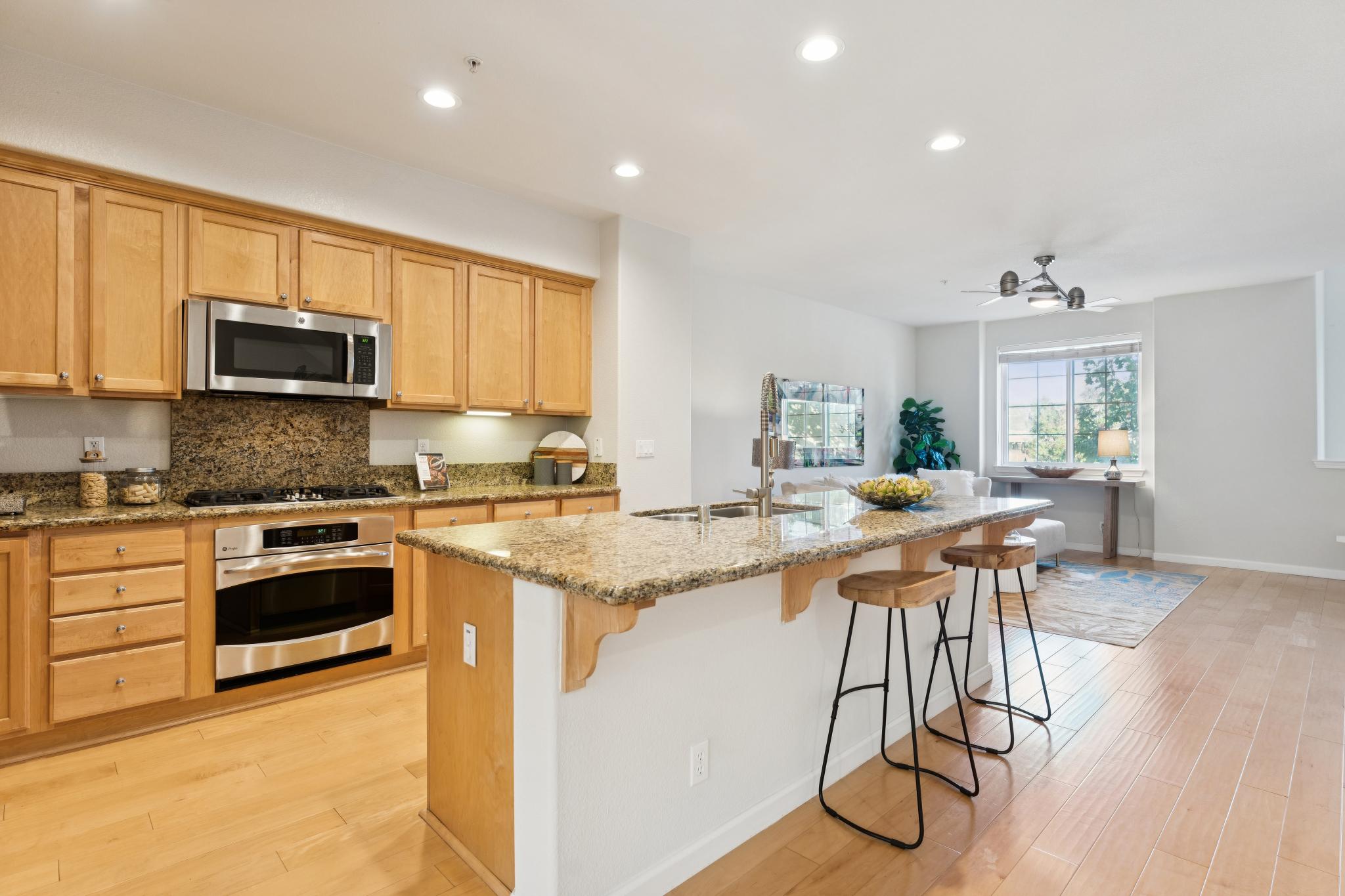 Kitchen with wood cabinets, center island and stainless steel appliances at Jetty Drive in Marina Bay, Richmond