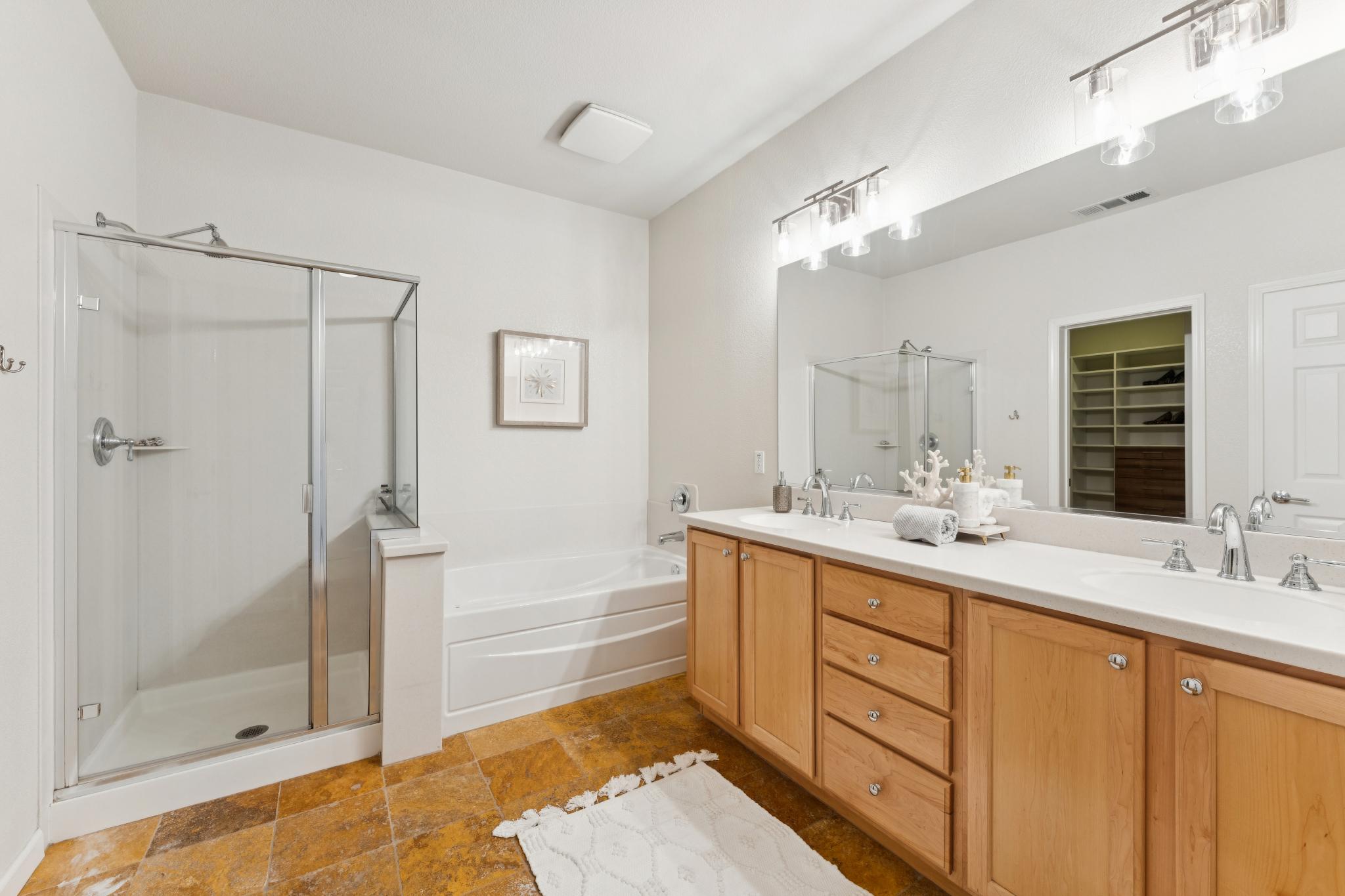 Primary bathroom with a double vanity, shower and bathtub at Jetty Drive in Marina Bay, Richmond
