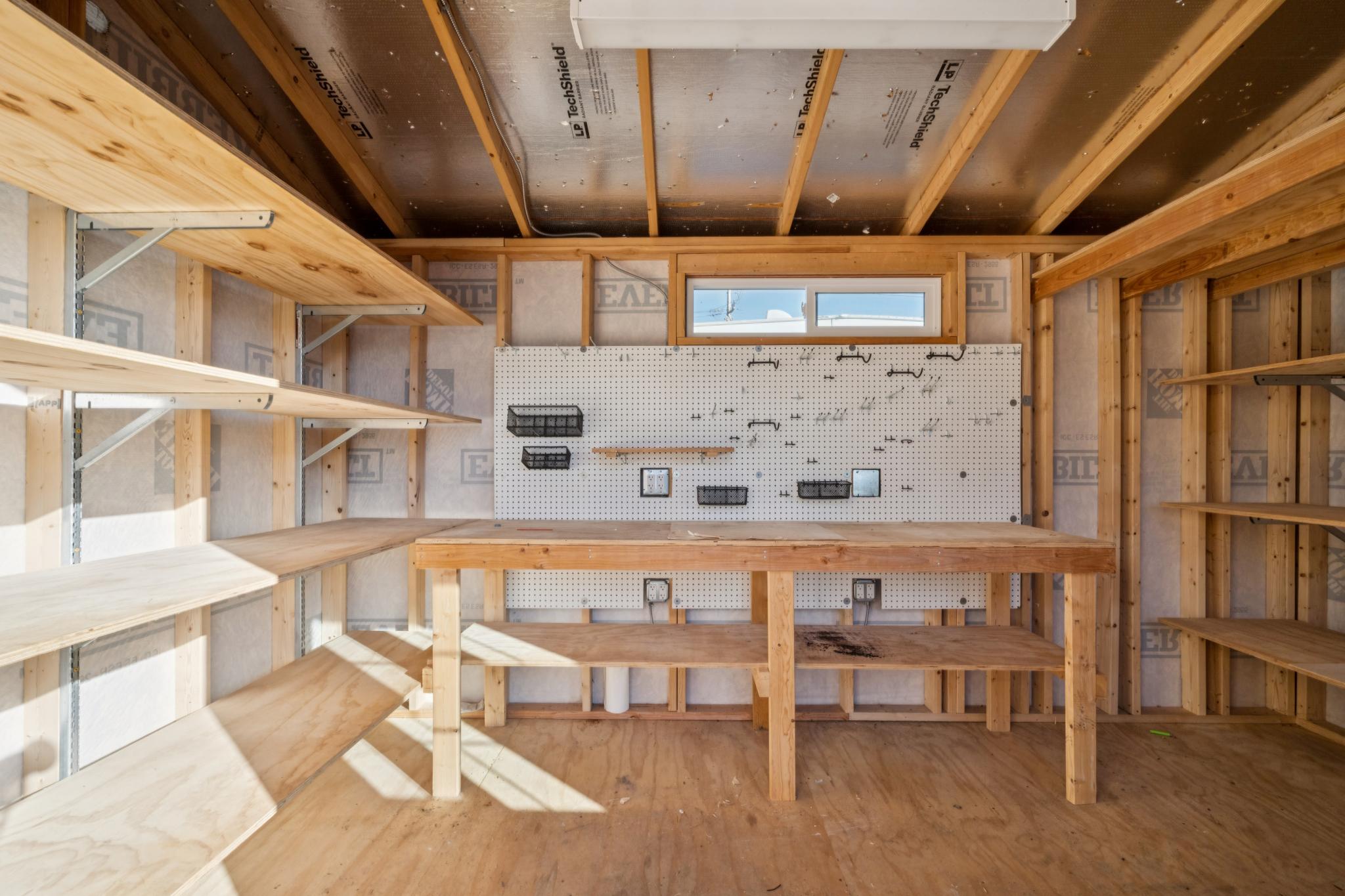 Workbench and shelving inside the detached workshop at 5104 Tehama Ave