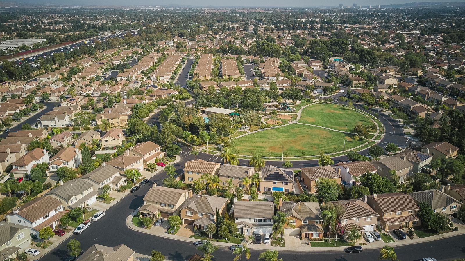 Aerial view of a master-planned suburban neighborhood with a central park
