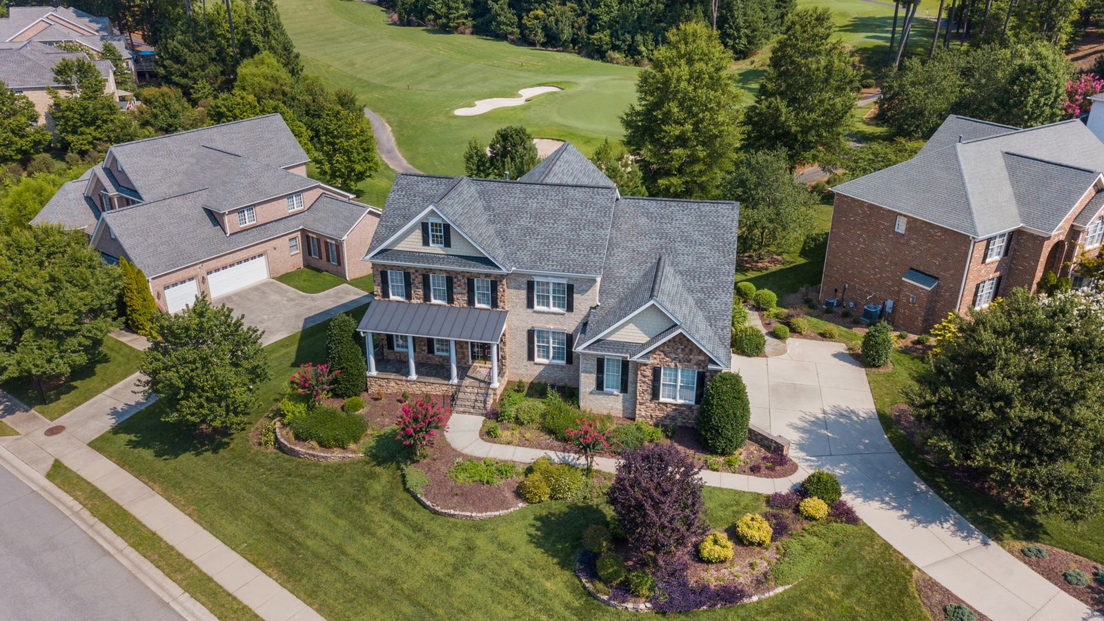 Aerial view of upscale homes along a golf course in a master-planned community