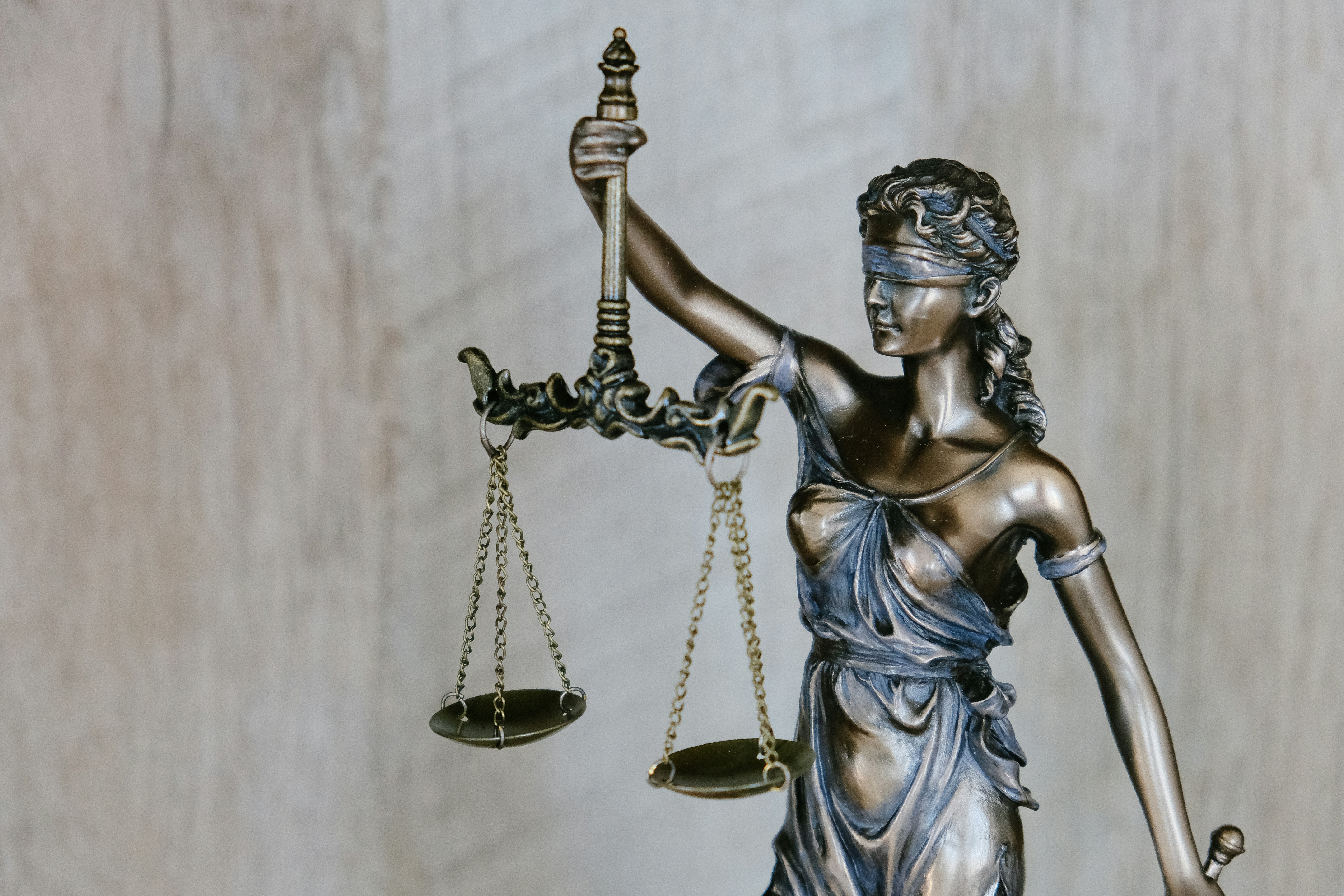 Image of blindfolded woman holding the Scales of Justice