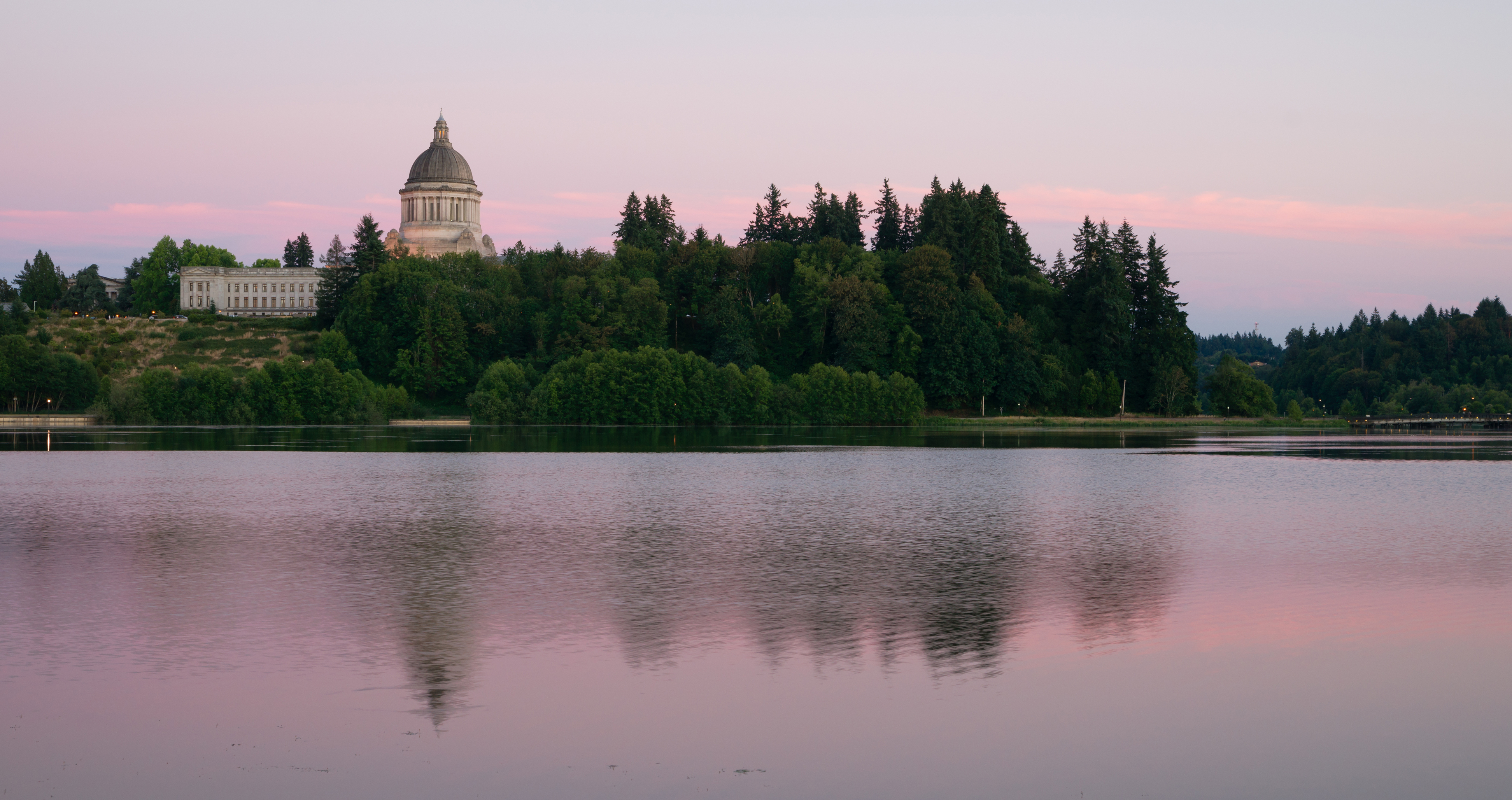 Washington State Capitol building in Olympia, Thurston County with waterfront view at sunset, representing local real estate and lifestyle