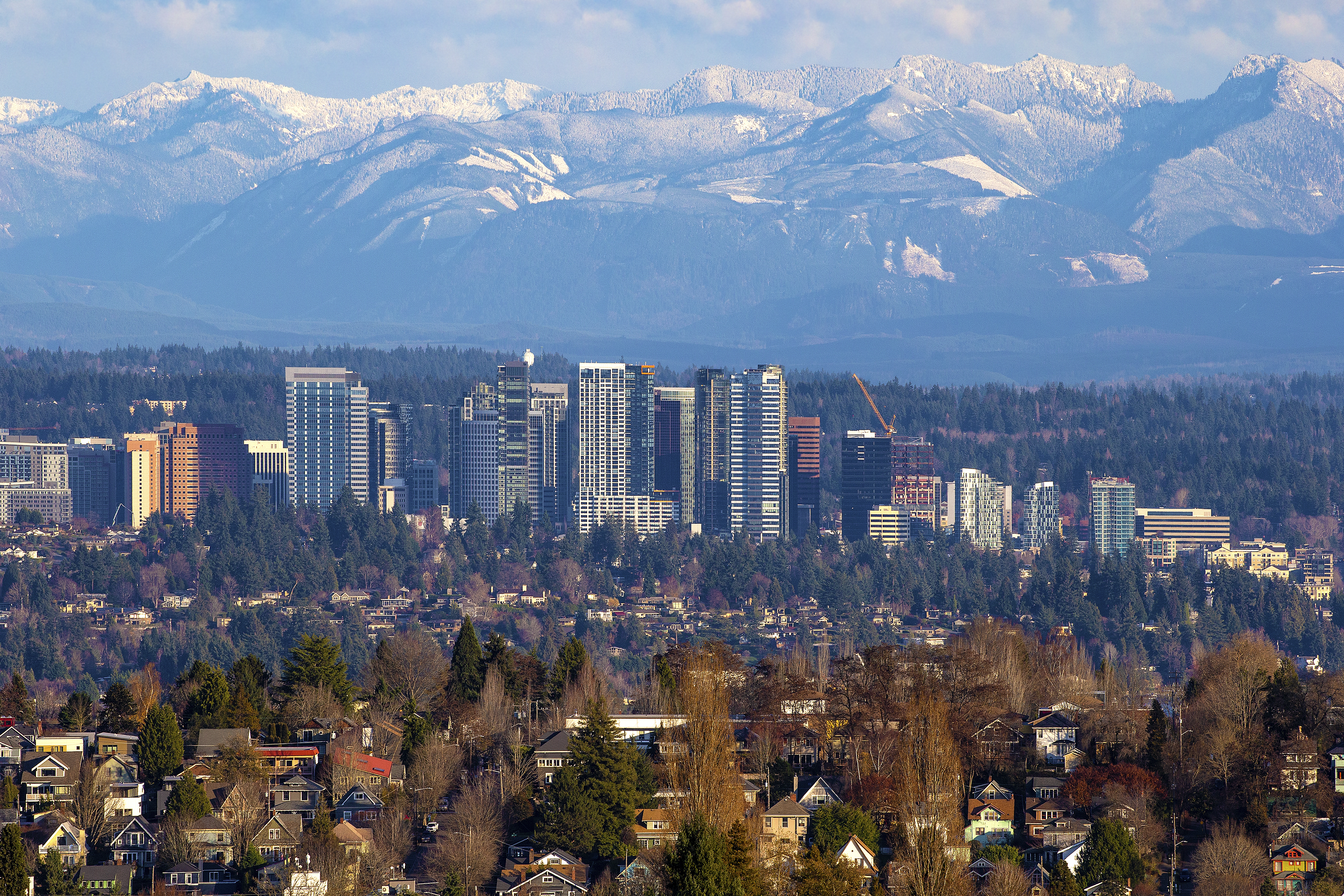 Bellevue skyline in King County Washington with residential neighborhoods and Cascade Mountains in the background, showcasing real estate and lifestyle in the Seattle metro area
