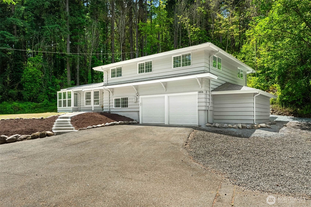 Beautiful two-story home surrounded by mature trees in the South Sound, representing the types of homes Heather Redal and Redal Homes help buyers find throughout Gig Harbor, Tacoma, and Western Washington.
