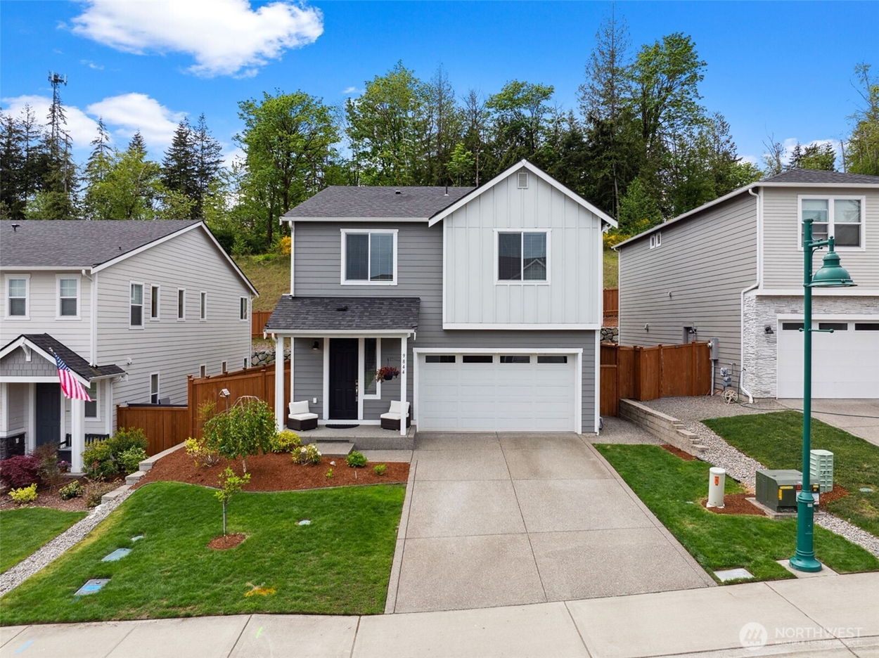 Modern single-family home in Gig Harbor Washington with landscaped yard and driveway, representing residential real estate in the Gig Harbor housing market