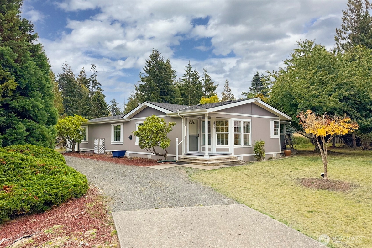 Single-story Western Washington home with a landscaped yard, representing a property that may require a change in pricing or listing strategy to attract buyers.