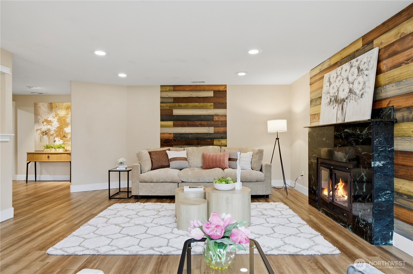 Staged living room with updated flooring, lighting, and fireplace, illustrating home preparation and improvements before selling in Western Washington.
