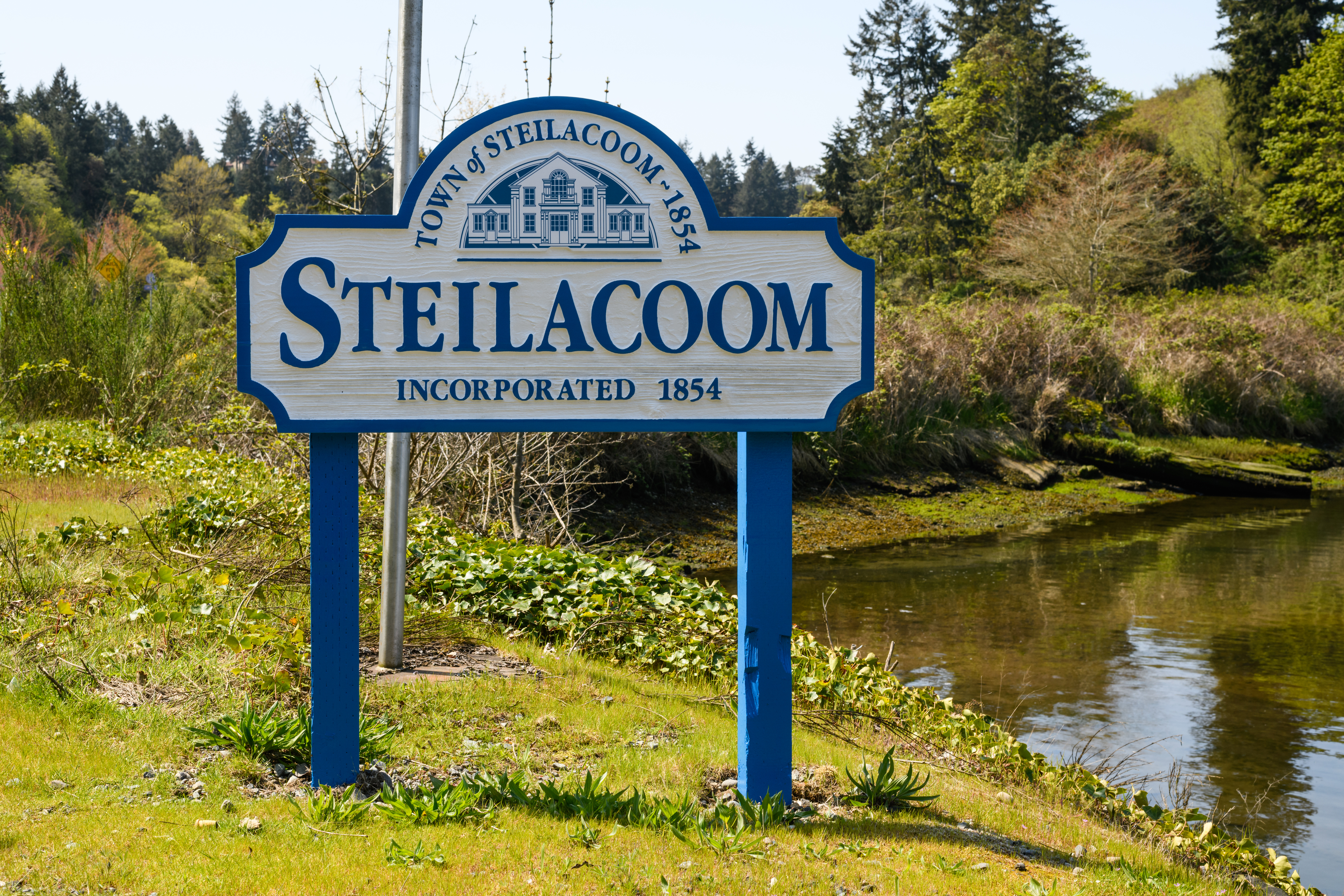 Welcome sign for the Town of Steilacoom, Washington, one of the oldest communities in the state and a popular residential area for JBLM military families seeking waterfront living and a small-town atmosphere.