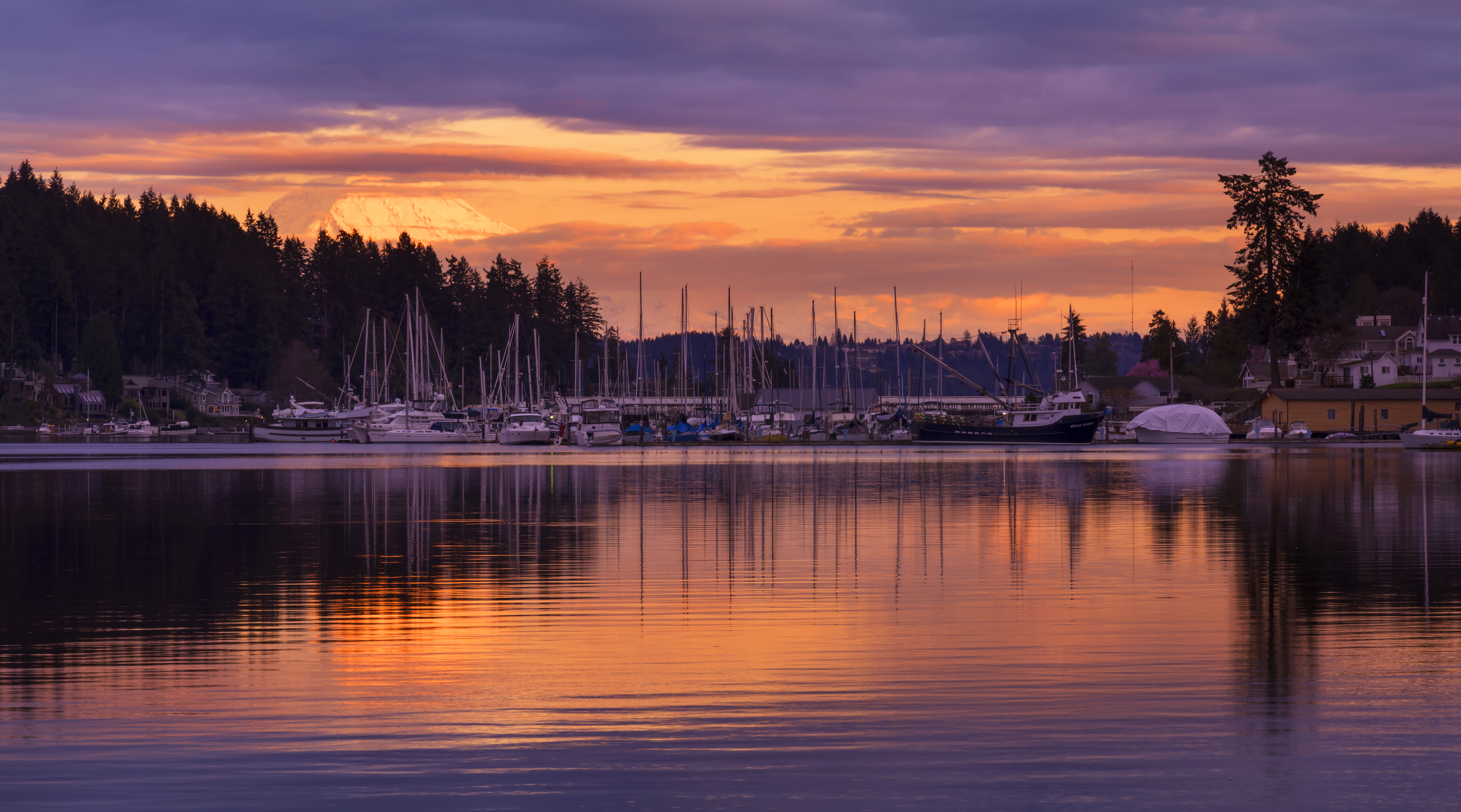 Gig Harbor marina at sunset with Mount Rainier and waterfront homes in Washington
