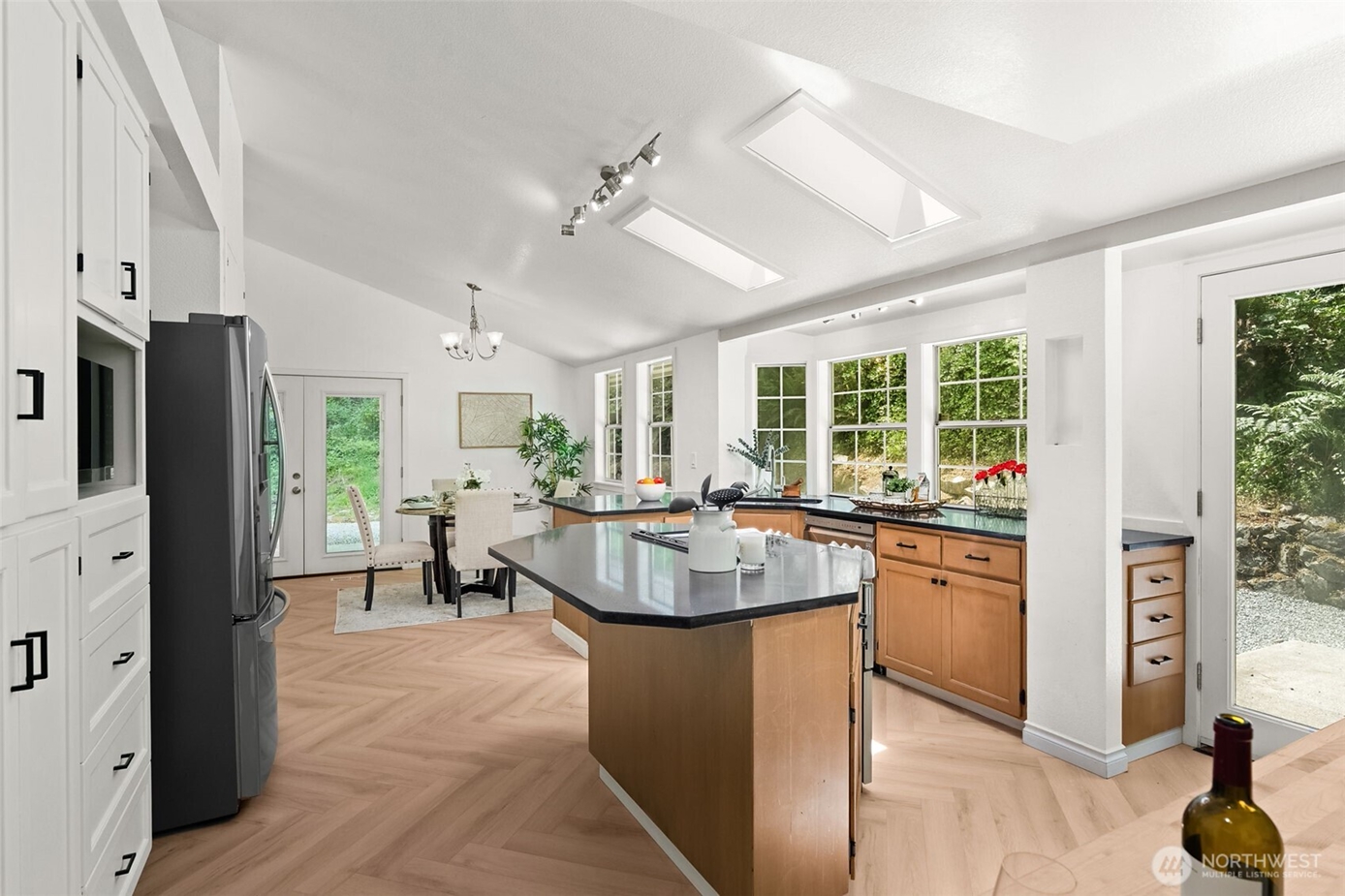 Bright, updated kitchen with abundant natural light, skylights, a center island, and modern finishes in a Gig Harbor home listed by Heather Redal and Redal Homes, illustrating the types of strategic kitchen improvements that appeal to South Sound home buyers.