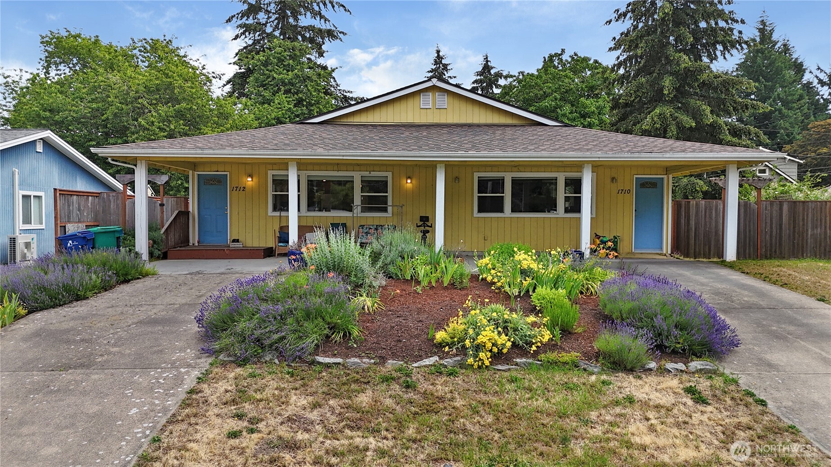 Duplex property in Olympia, Washington featuring two side-by-side residential units with private entrances and landscaped front yard, illustrating a VA loan house hacking opportunity for military members and veterans near JBLM.