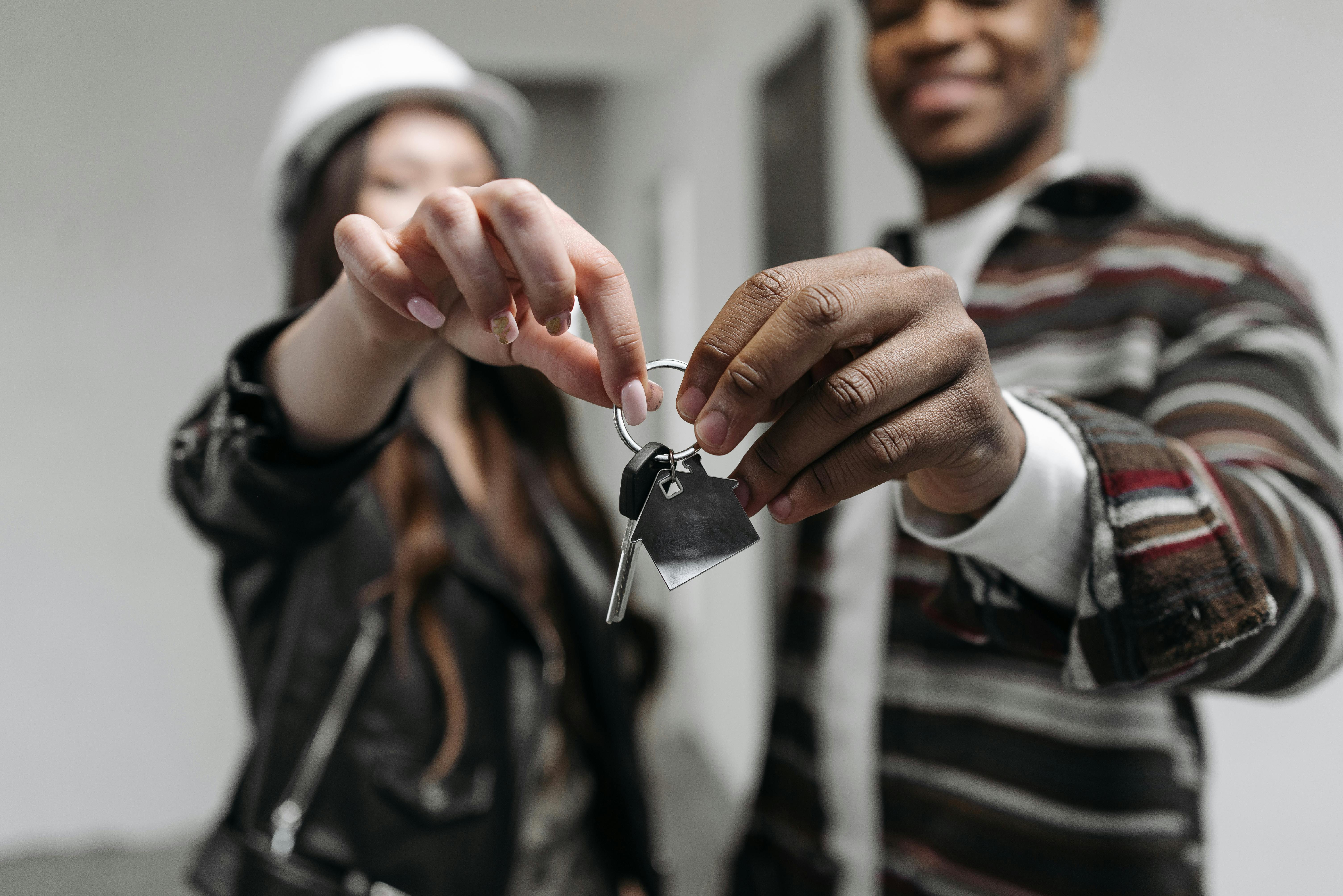 Homeowners holding up the keys to their new property