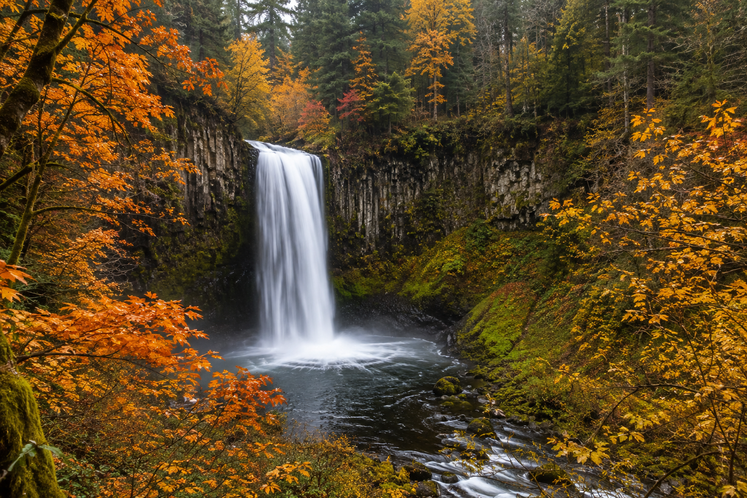 Oregon waterfall in autumn with color changed leaves