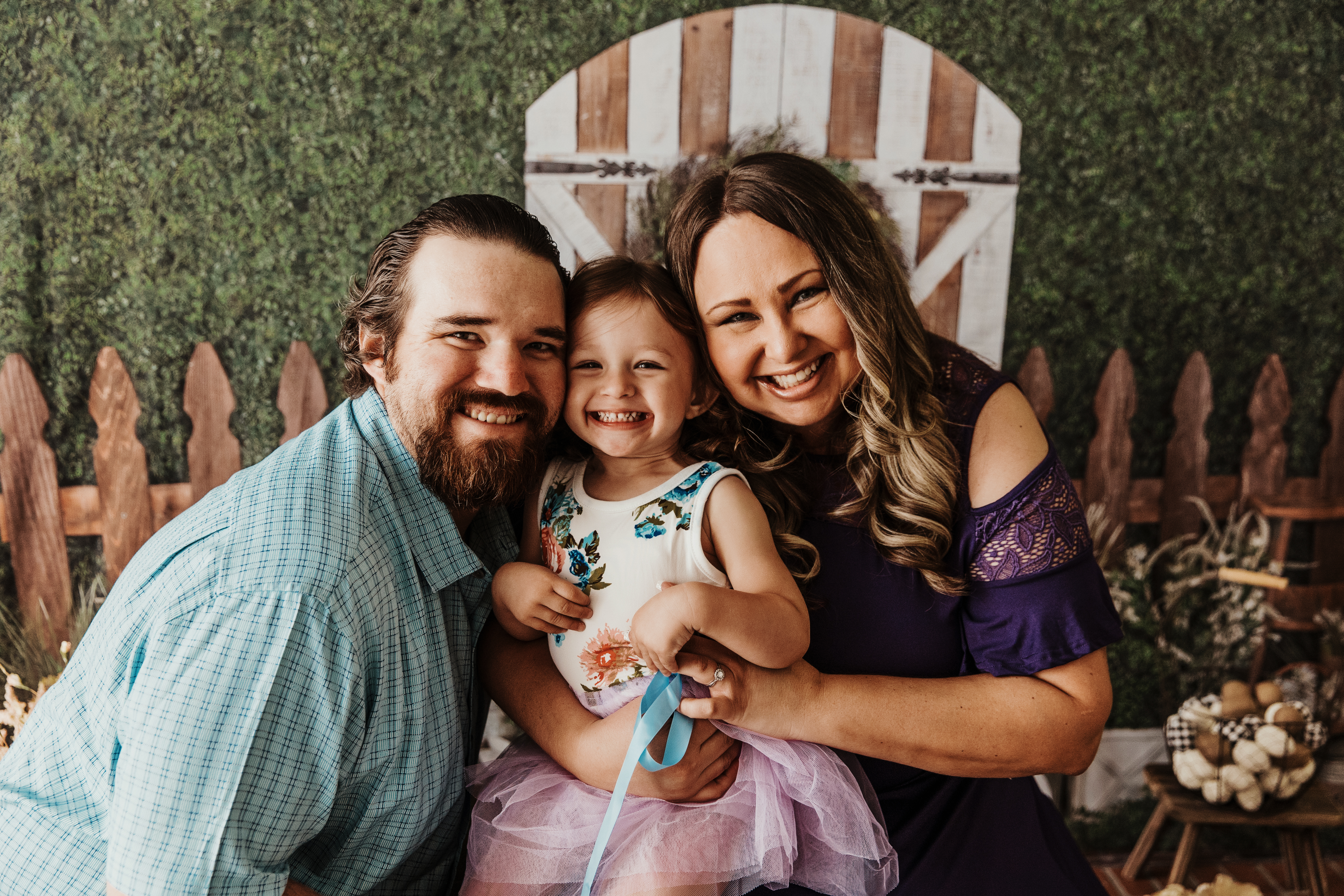 Happy family photo of Danielle, Frank, and their daughter Maddie, smiling together as they plan for a secure financial future.