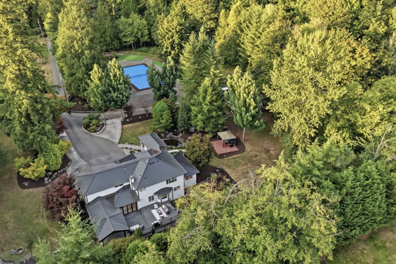 Bunk Foss luxury estate in Snohomish, WA, surrounded by mature trees with private grounds, outdoor entertaining areas and a sports court.