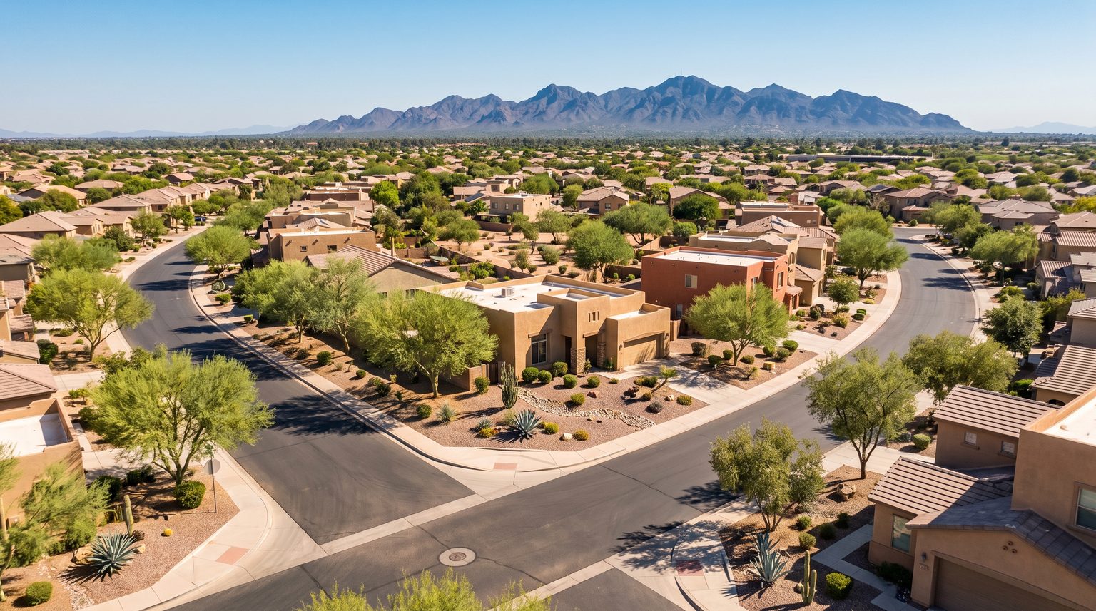 Aerial view of suburban Chandler, Arizona neighborhoods with desert landscaping and mountain backdrop