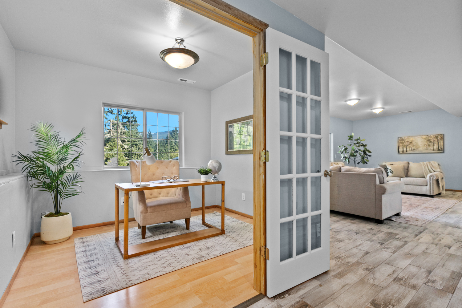 A finished basement with office and living area.