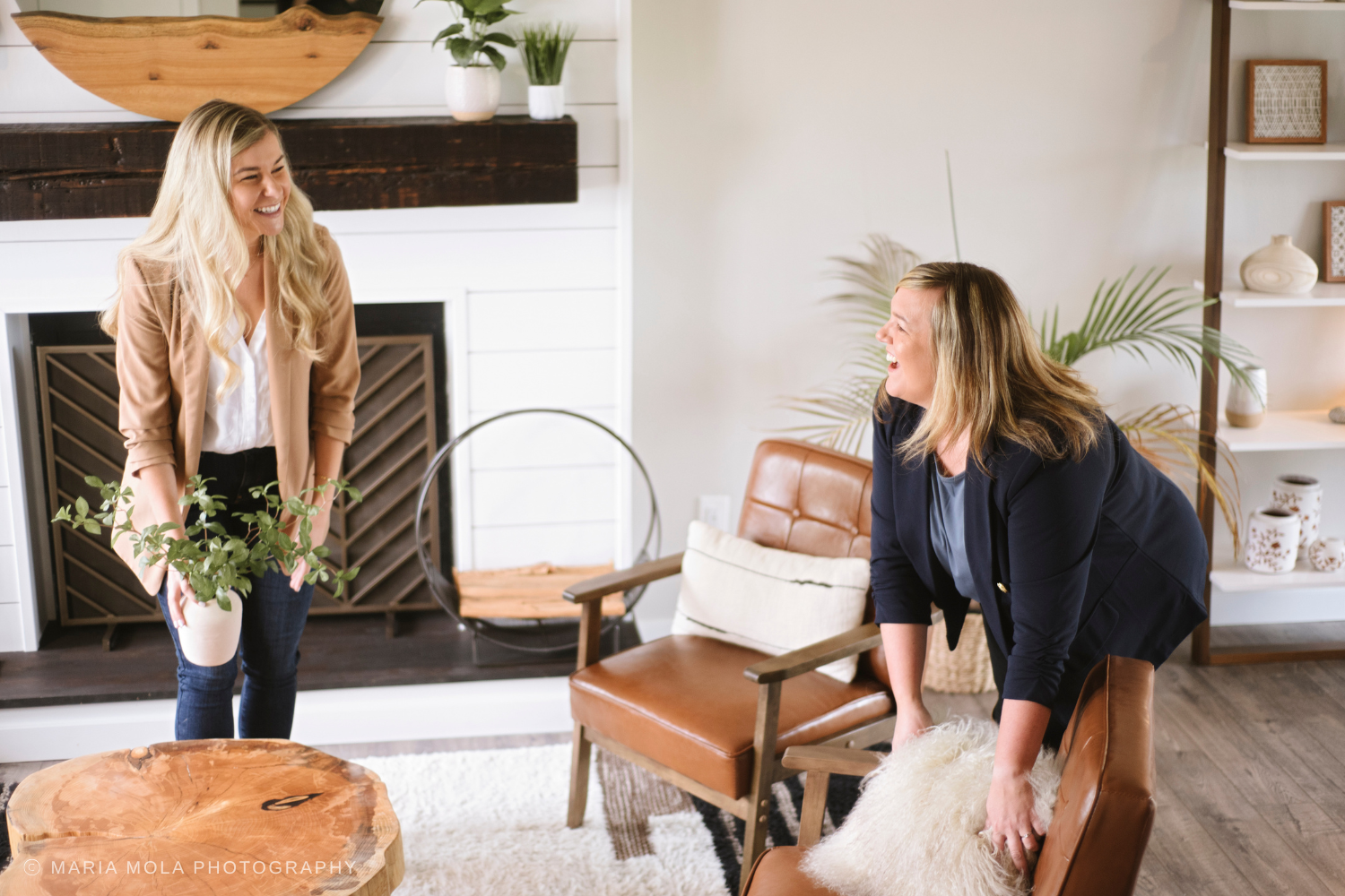 Two real estate agents staging and organizing a home