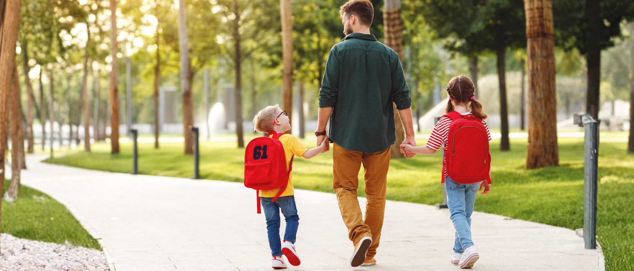 Parent walking children to school.
