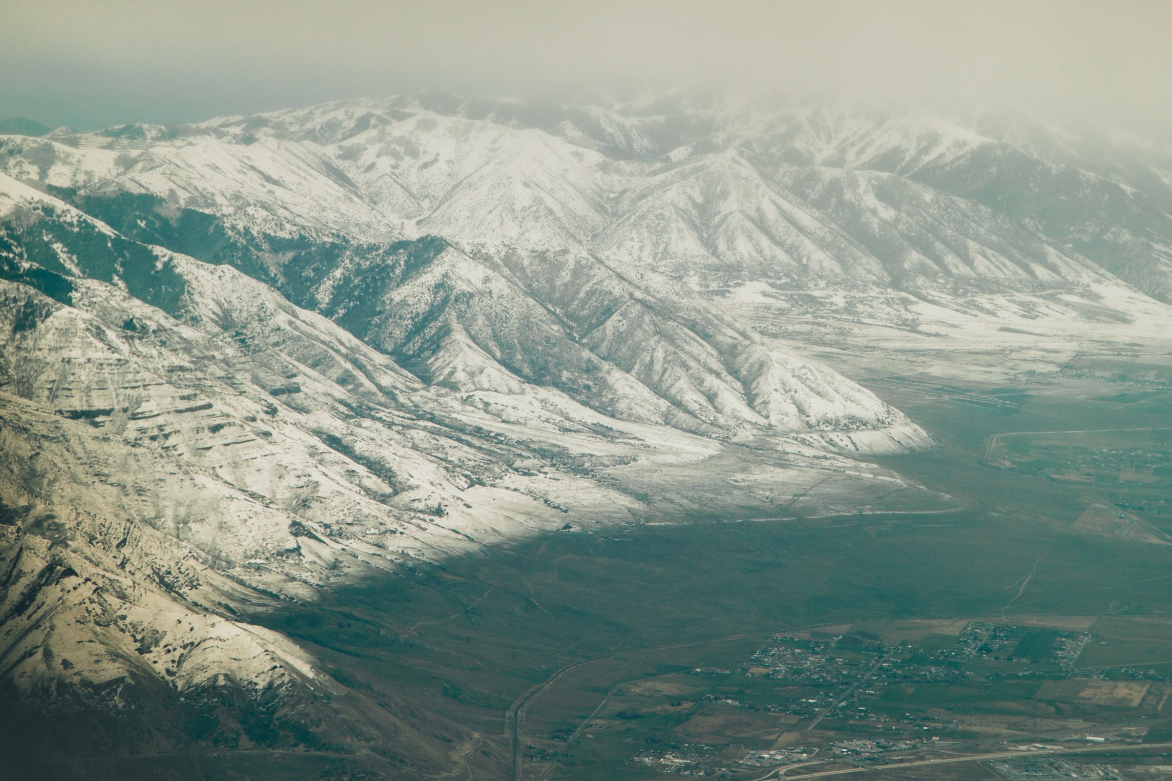 Snow-covered Wasatch Range dropping into the Salt Lake Valley, seen from the air