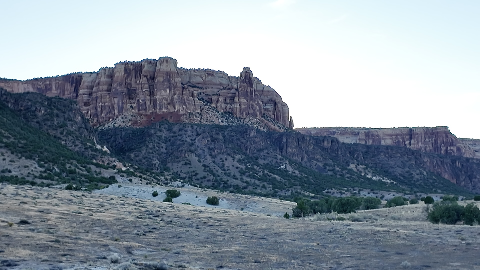 Red rock cliffs of the Colorado National Monument rising above the Redlands neighborhood in Grand Junction, Colorado