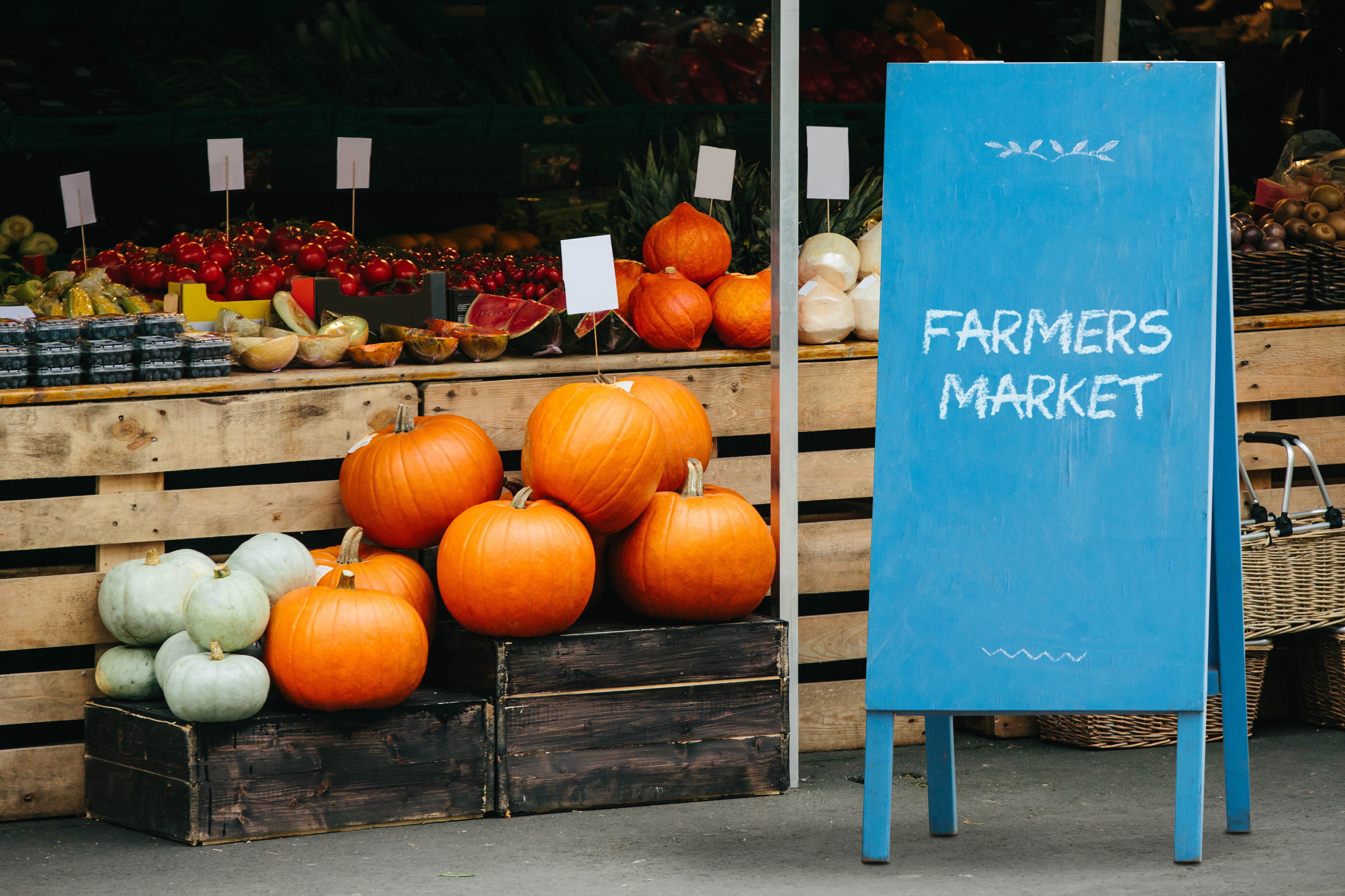 Farmers market stall with fresh produce and a 