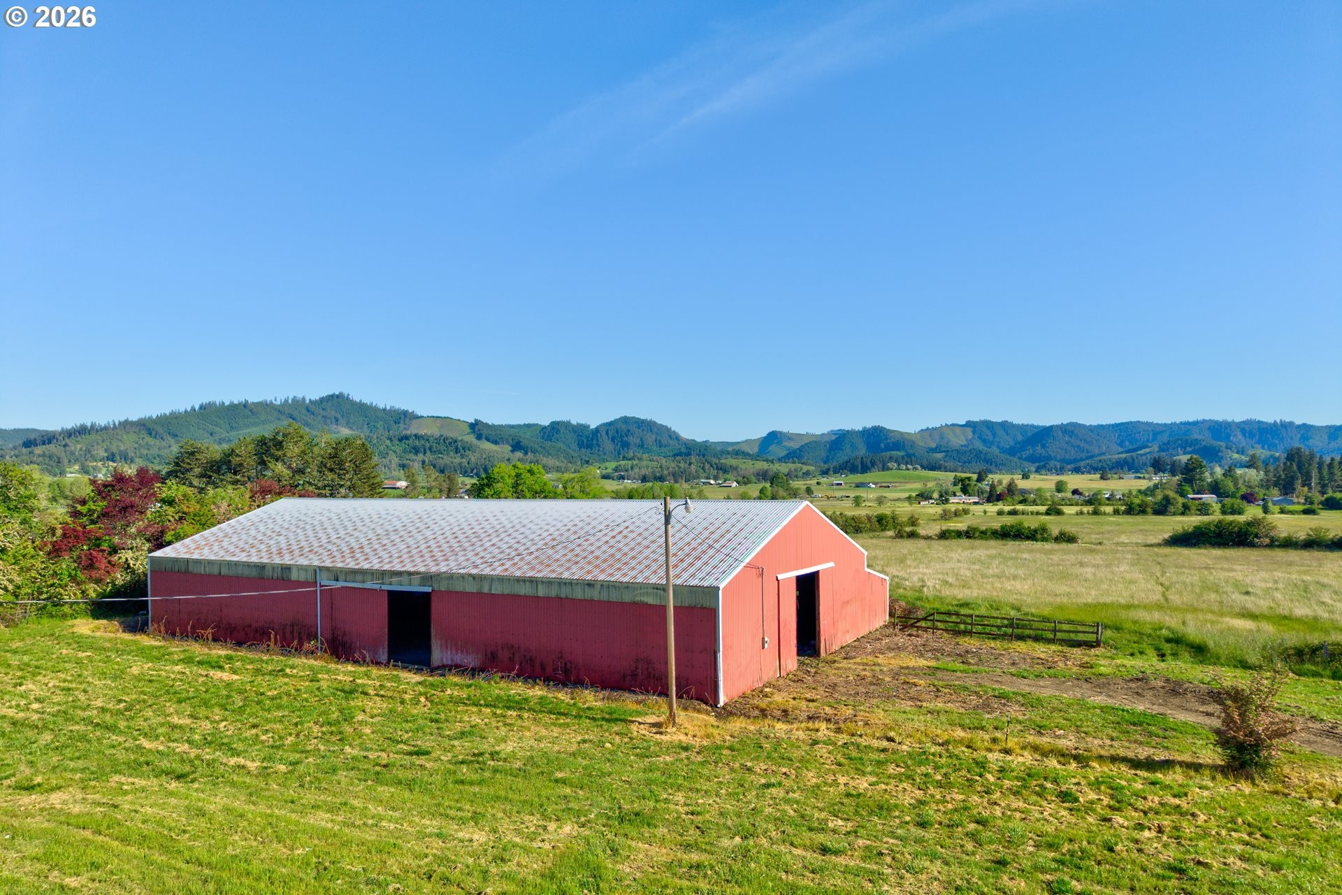 Red horse arena on 13.58 acres at 2529 Northside Rd in Sutherlin with mountain views beyond