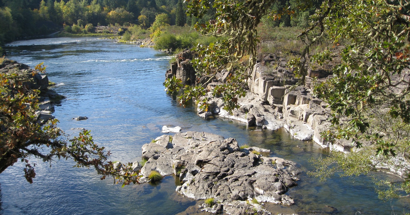 North Umpqua River bordered by rock ledges and autumn trees in Douglas County, Oregon