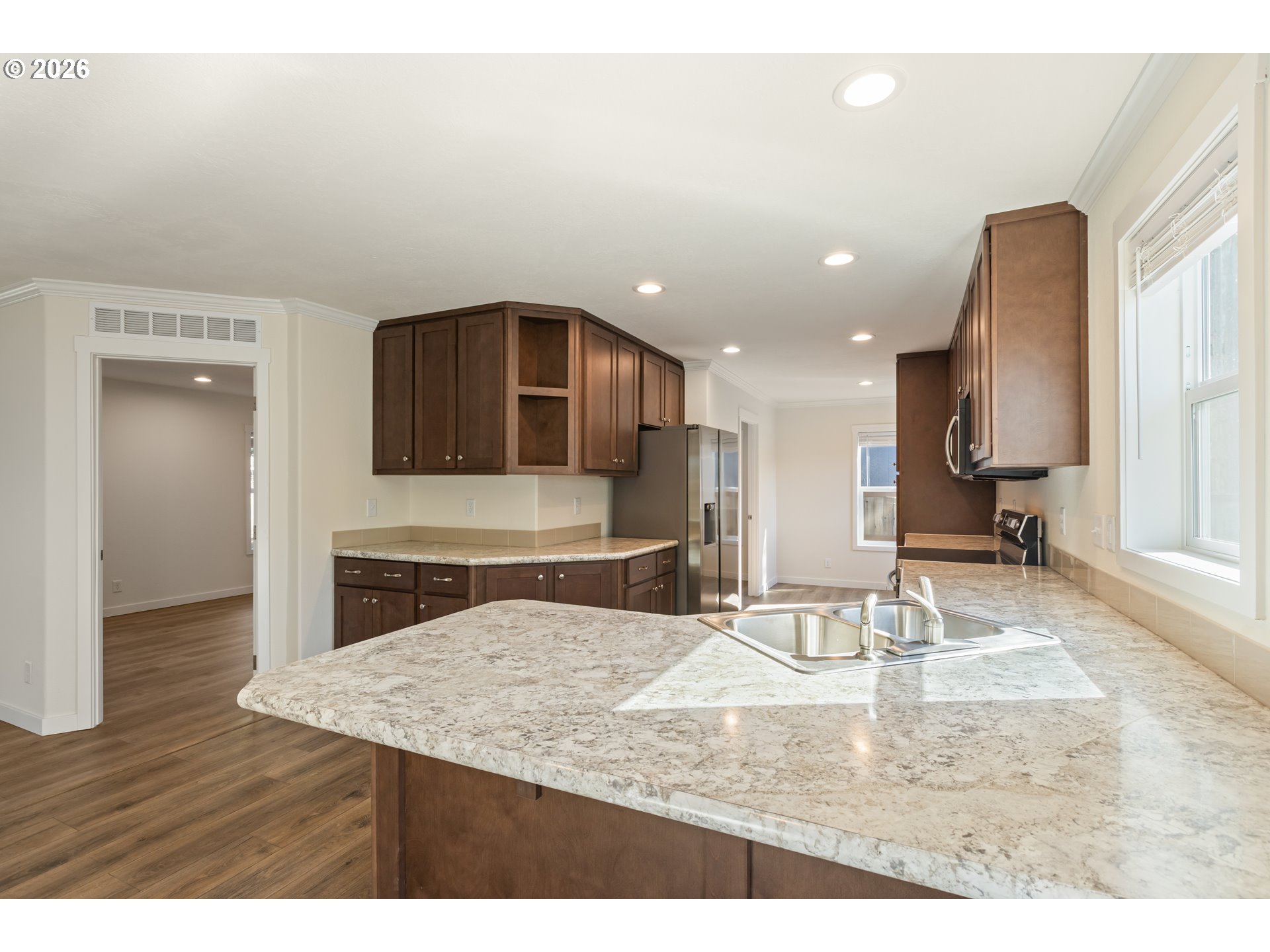 Unstaged kitchen with stainless appliances and generous counters at 271 SE Robinson St in Winston