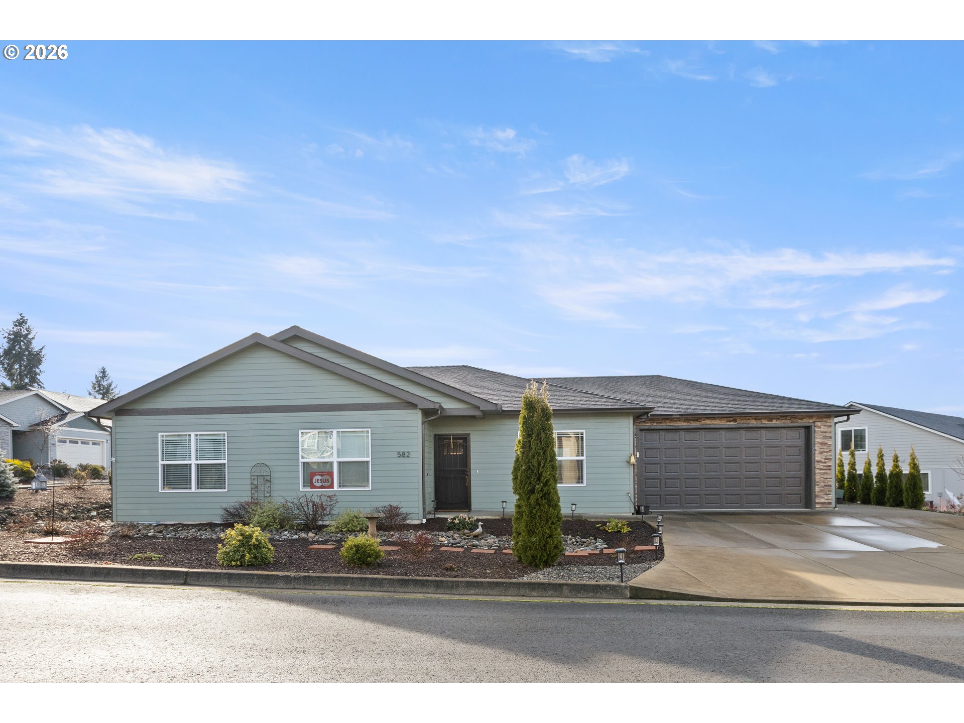 Front exterior and attached garage at 582 Fairway Estates Dr in Sutherlin, Oregon