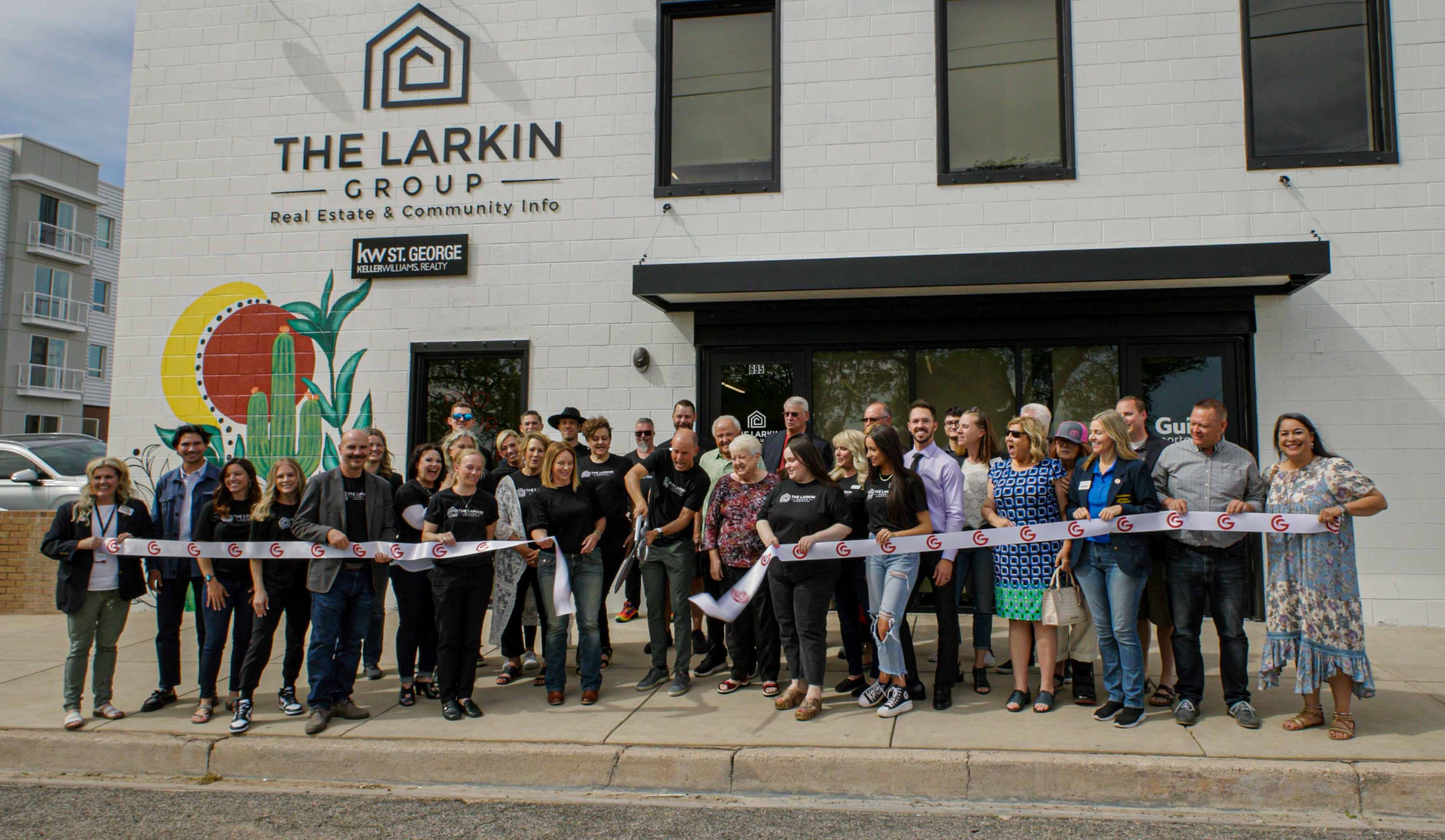 Group photo of The Larkin Group team and community members during a ribbon-cutting ceremony outside the new Larkin Group headquarters building in St. George, Utah.