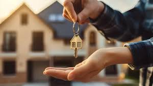 Close-up of a homebuyer receiving house keys in front of a home, representing closing day and homeownership in St. George, Utah.