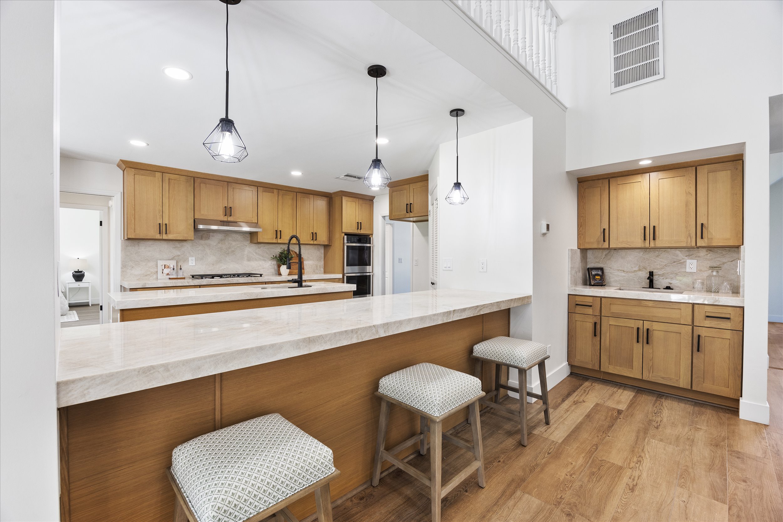 Bright kitchen in a Bakersfield home for sale with a large island and wood cabinetry