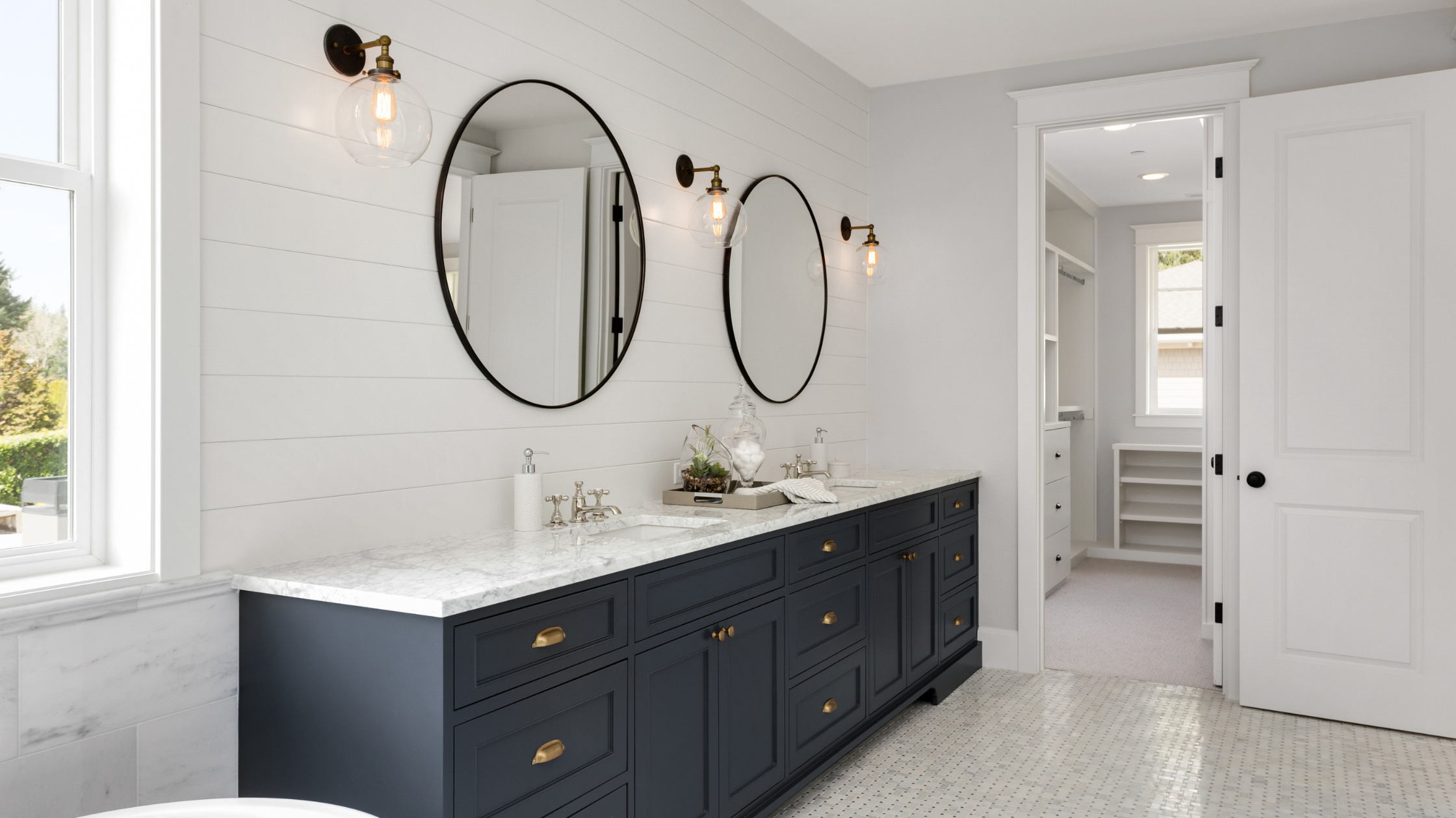 Clean, modern bathroom with double vanity and marble countertops in a Bakersfield home, showing how presentation impacts buyer perception