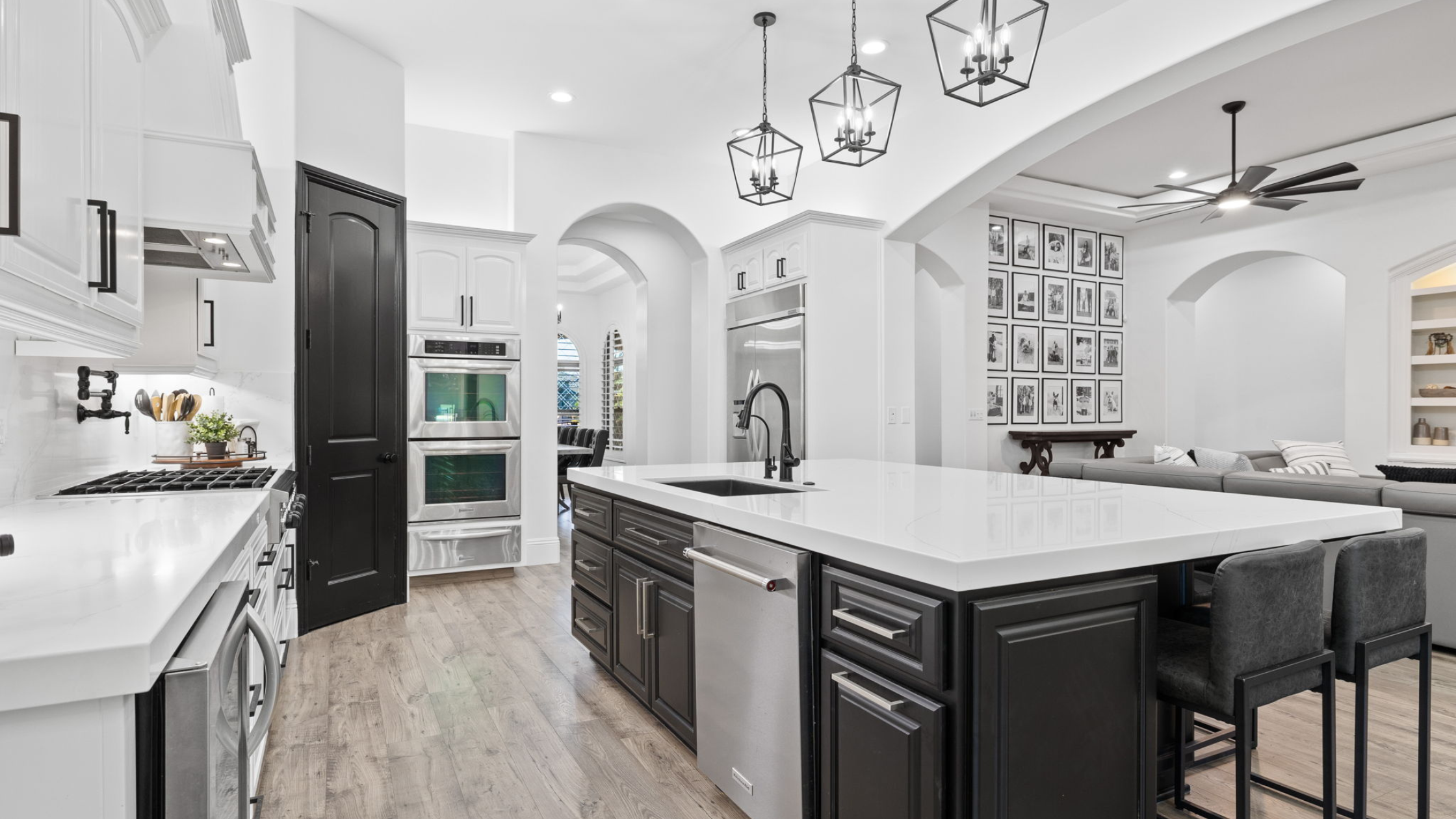 On-trend kitchen with white and black cabinets and white countertops