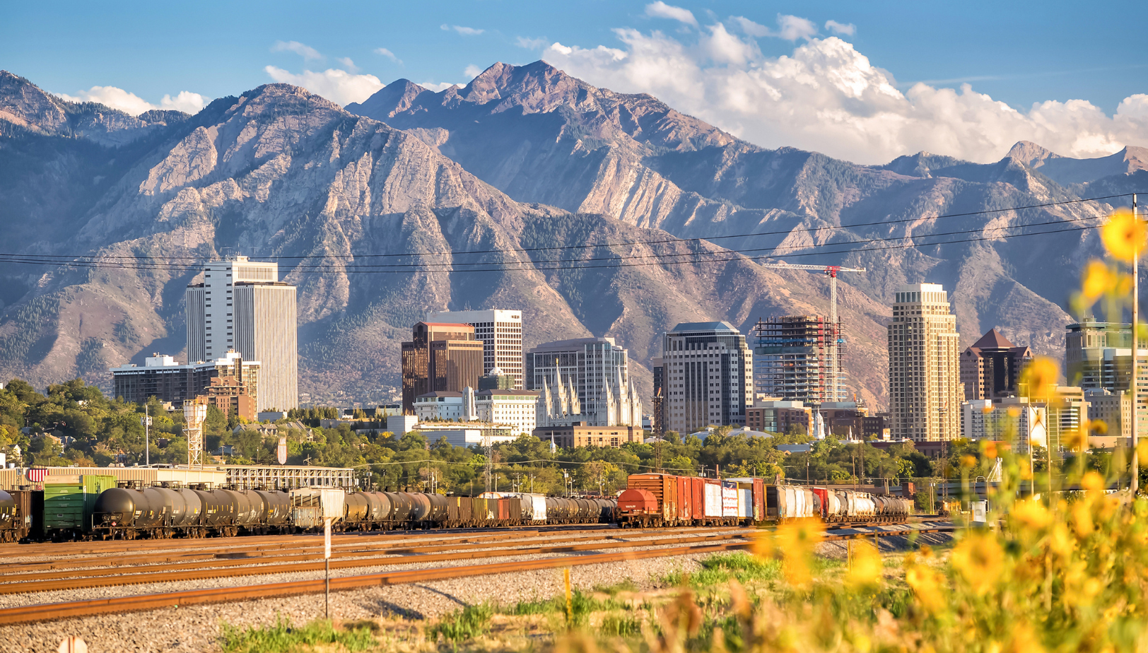 Salt Lake City skyline with Wasatch Mountains, highlighting Utah real estate and urban growth.