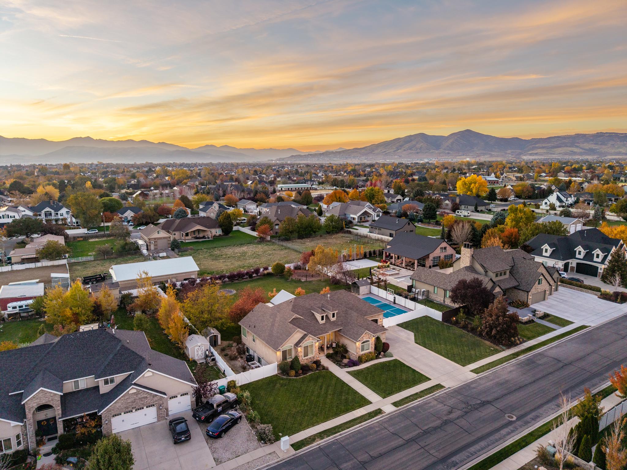 A Utah neighborhood with modern homes and mountains in the background, symbolizing a recovering housing market and improving affordability.