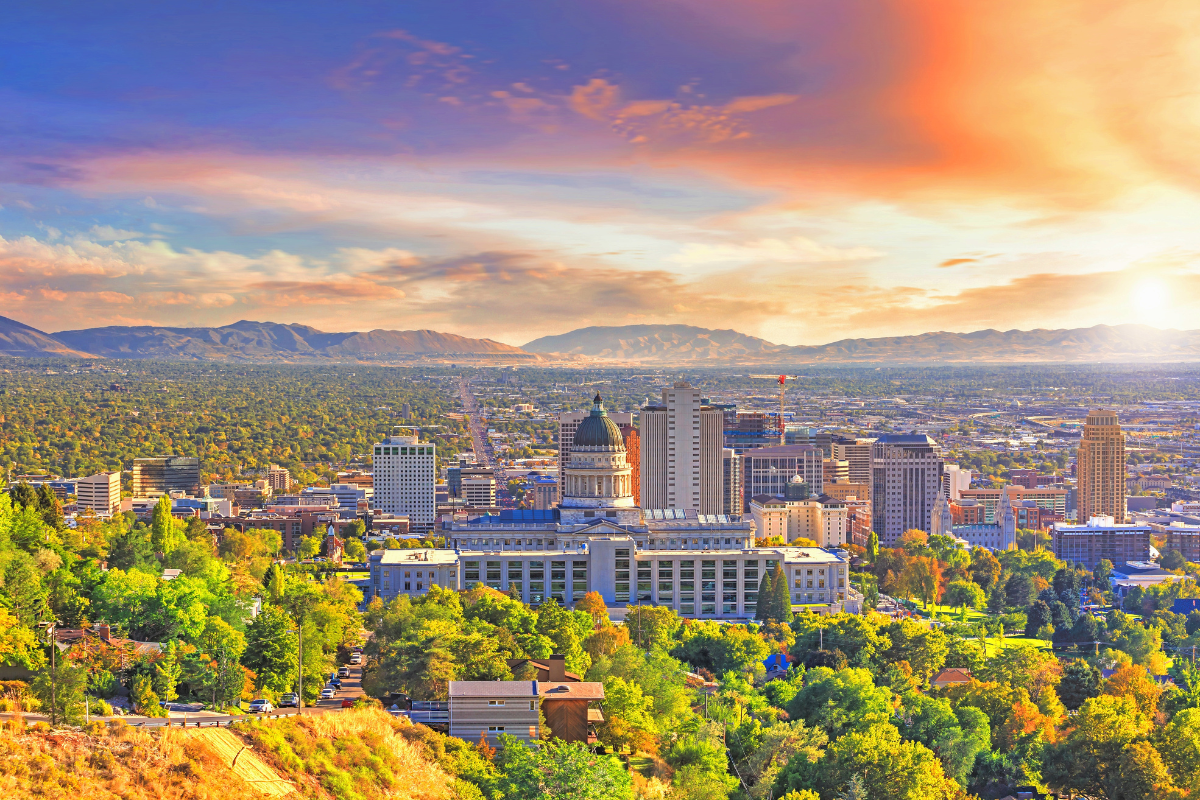 Aerial view of Salt Lake City neighborhoods with homes and mountains in the background, representing Utah’s housing market and affordability challenges.
