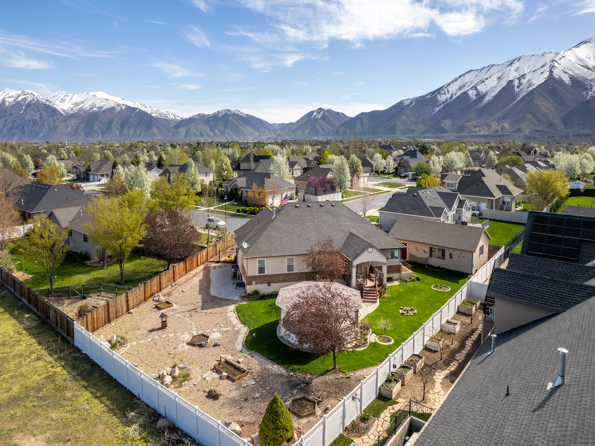 Utah residential neighborhood in early spring with mountain views, representing opportunities to buy a home before the spring market rush