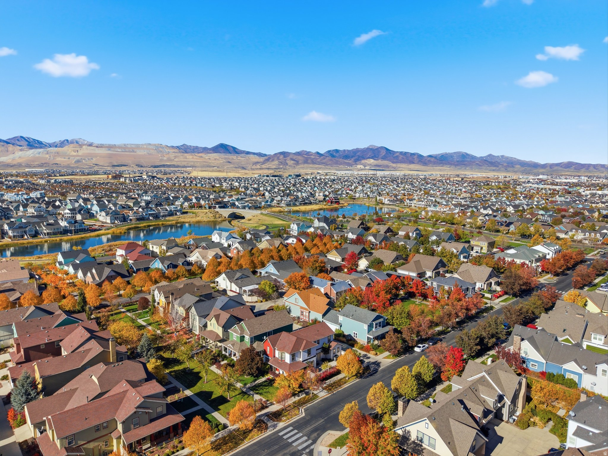 Aerial view of new Utah housing development with mixed-density homes and mountain backdrop symbolizing statewide zoning reform.