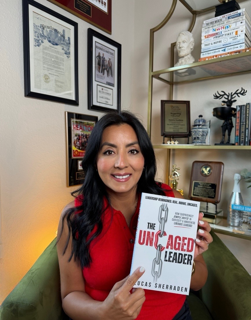 Daniela Sumbera holding The Uncaged Leader by Lucas Sherraden