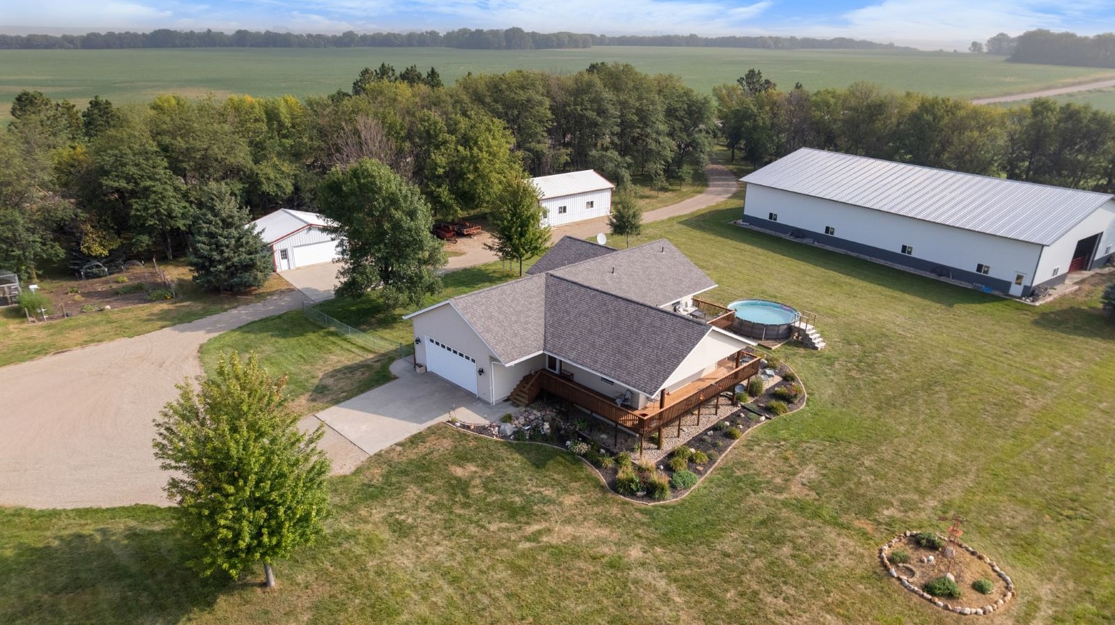 Aerial view of 9+ acre equestrian property for sale in Canton, South Dakota featuring ranch home, indoor riding arena, horse barn, and surrounding countryside.