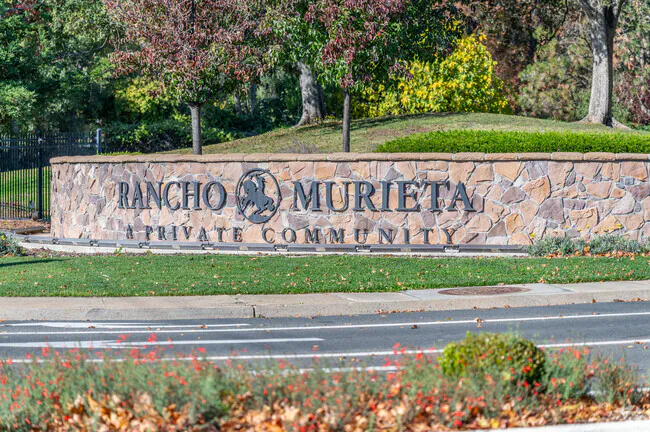 Scenic view of Rancho Murieta, California, featuring gated communities, golf courses, and lakes surrounded by rolling hills.